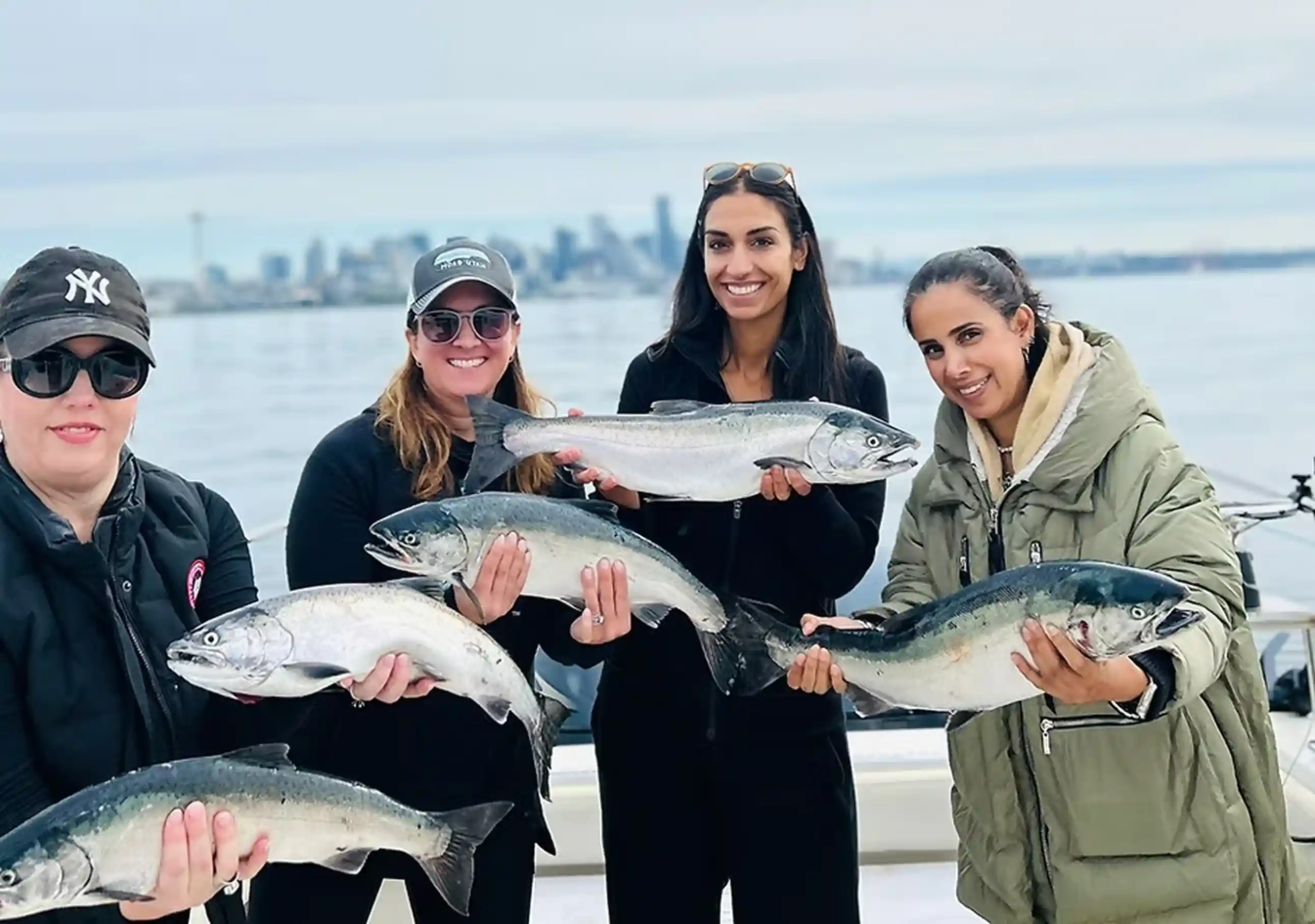 Group of women on a fishing charter boat holding fish