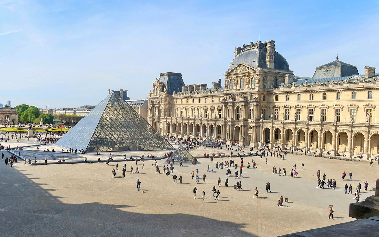 Louvre Museum courtyard with glass pyramid in Paris.
