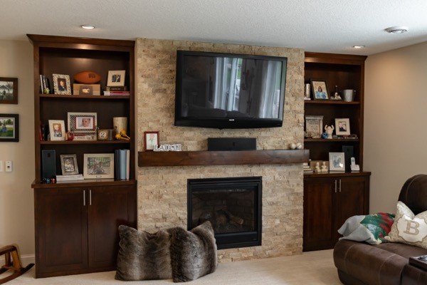 Family room with fireplace dark cabinet shelving