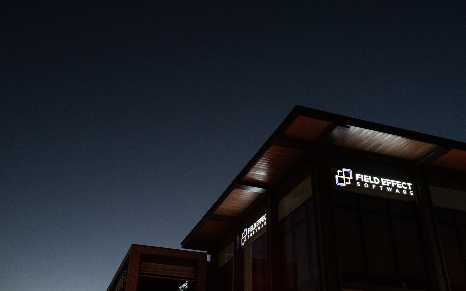 Field Effect logo on exterior at night.
