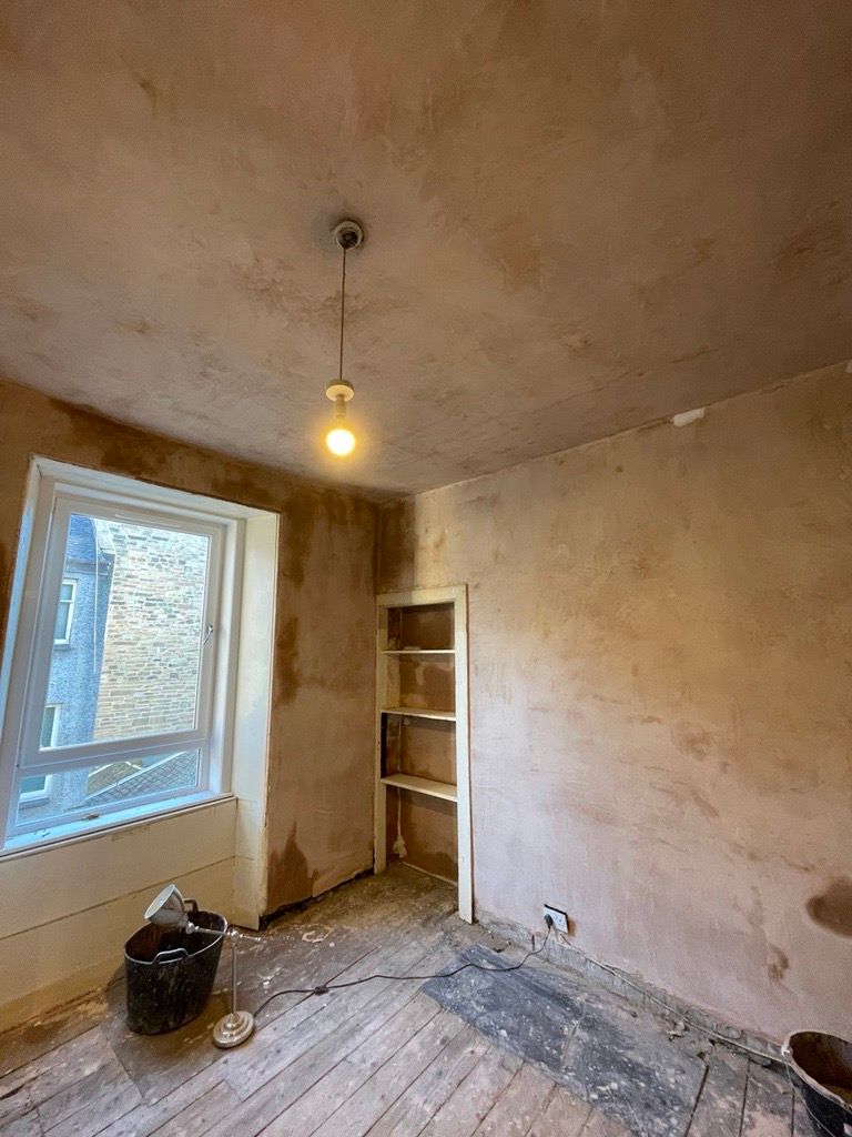 Freshly plastered room with window and alcove shelving