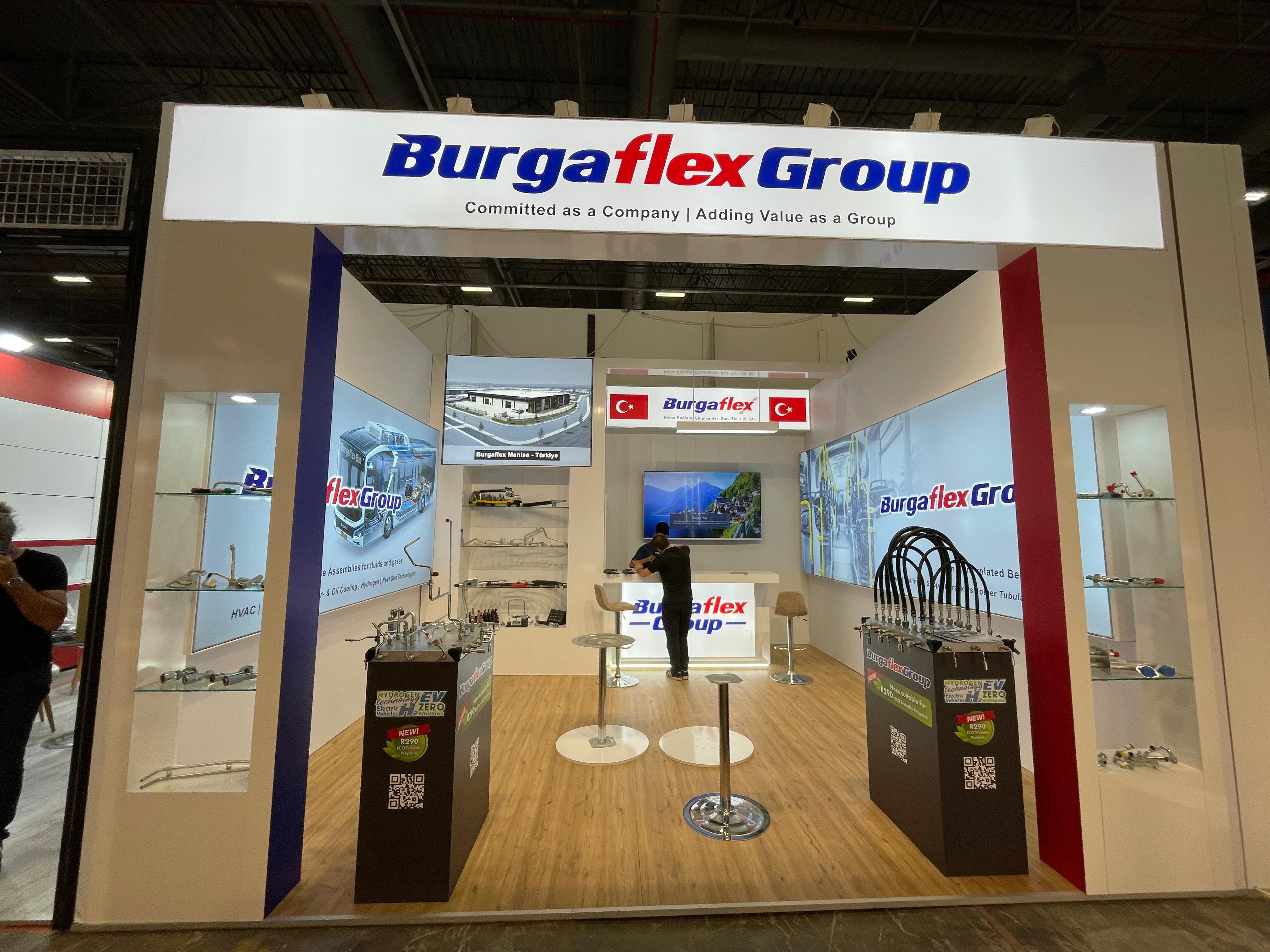 Illuminated header signage at the Burgaflex stand, reinforcing the corporate identity and brand visibility.
