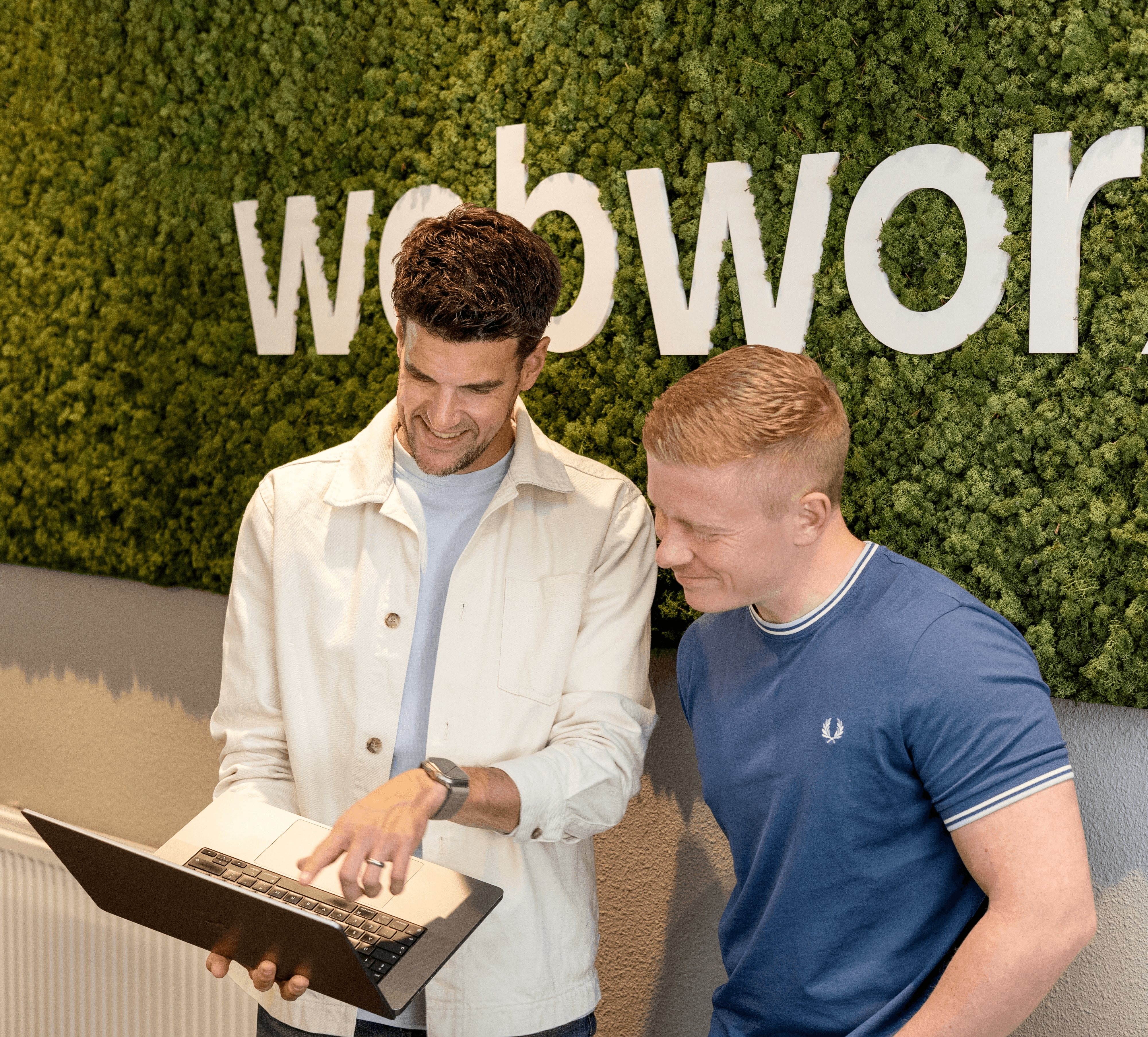 Two Men Using Laptop