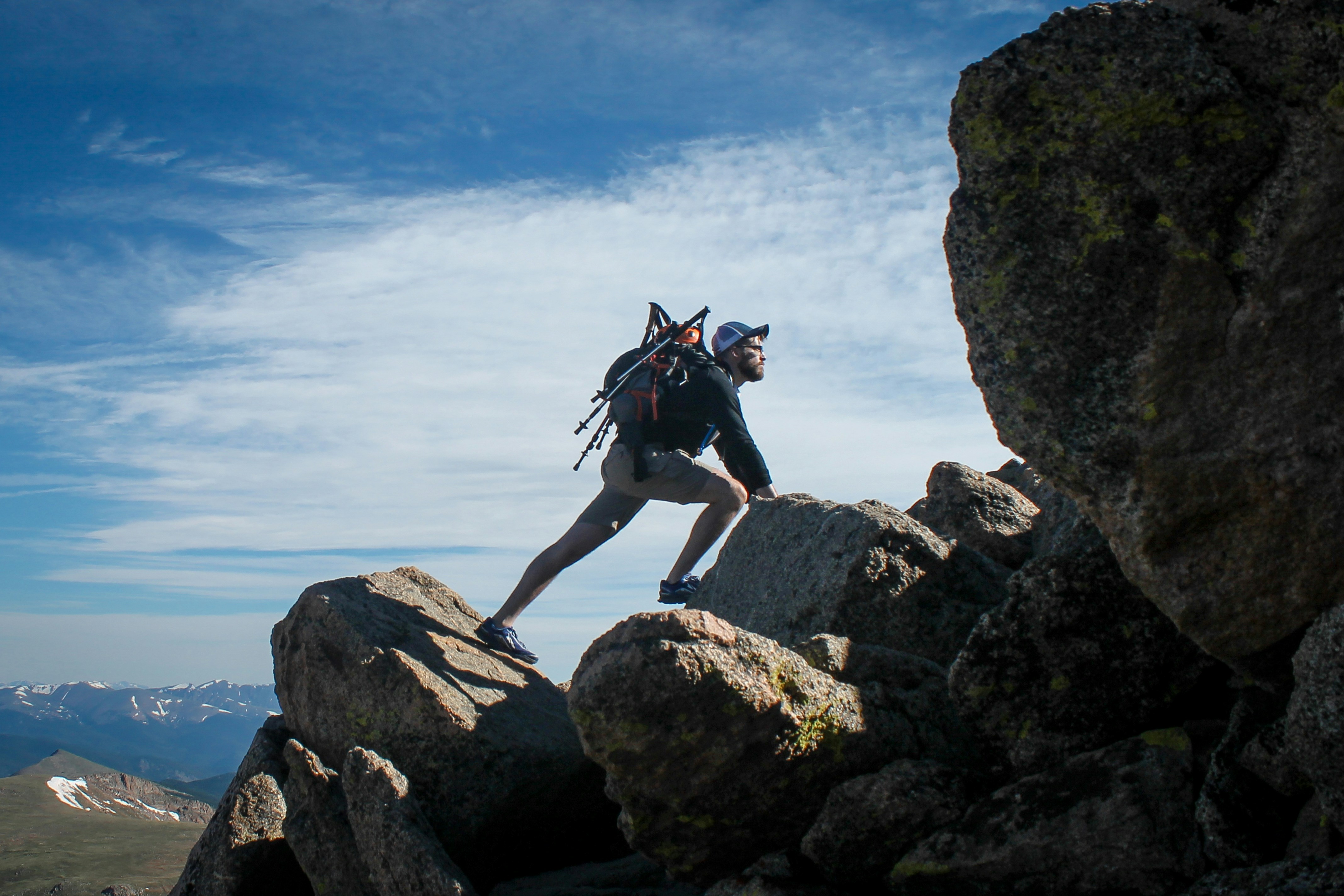 man climbing a mountain - Fall hiking outfit