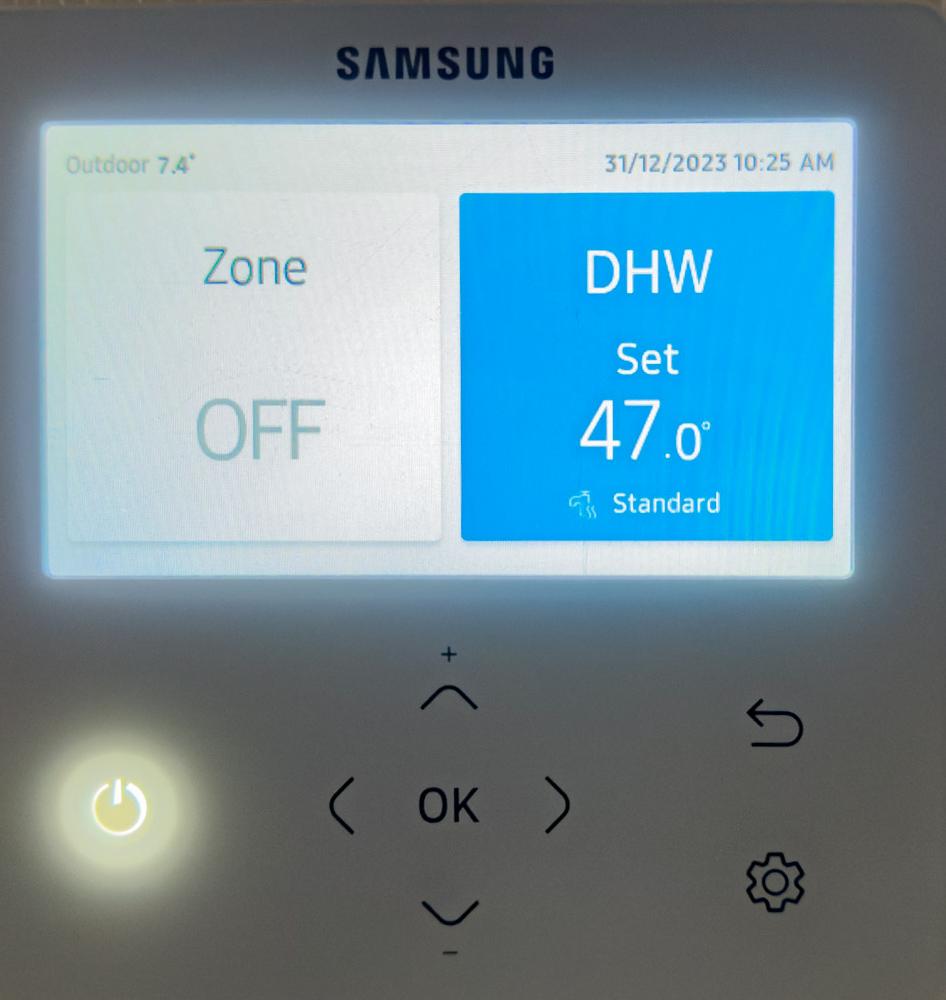 Heat pump controller display showing space heating zone set to off while DHW hot water mode is active — illustrating how heat pumps switch priority between heating and hot water
