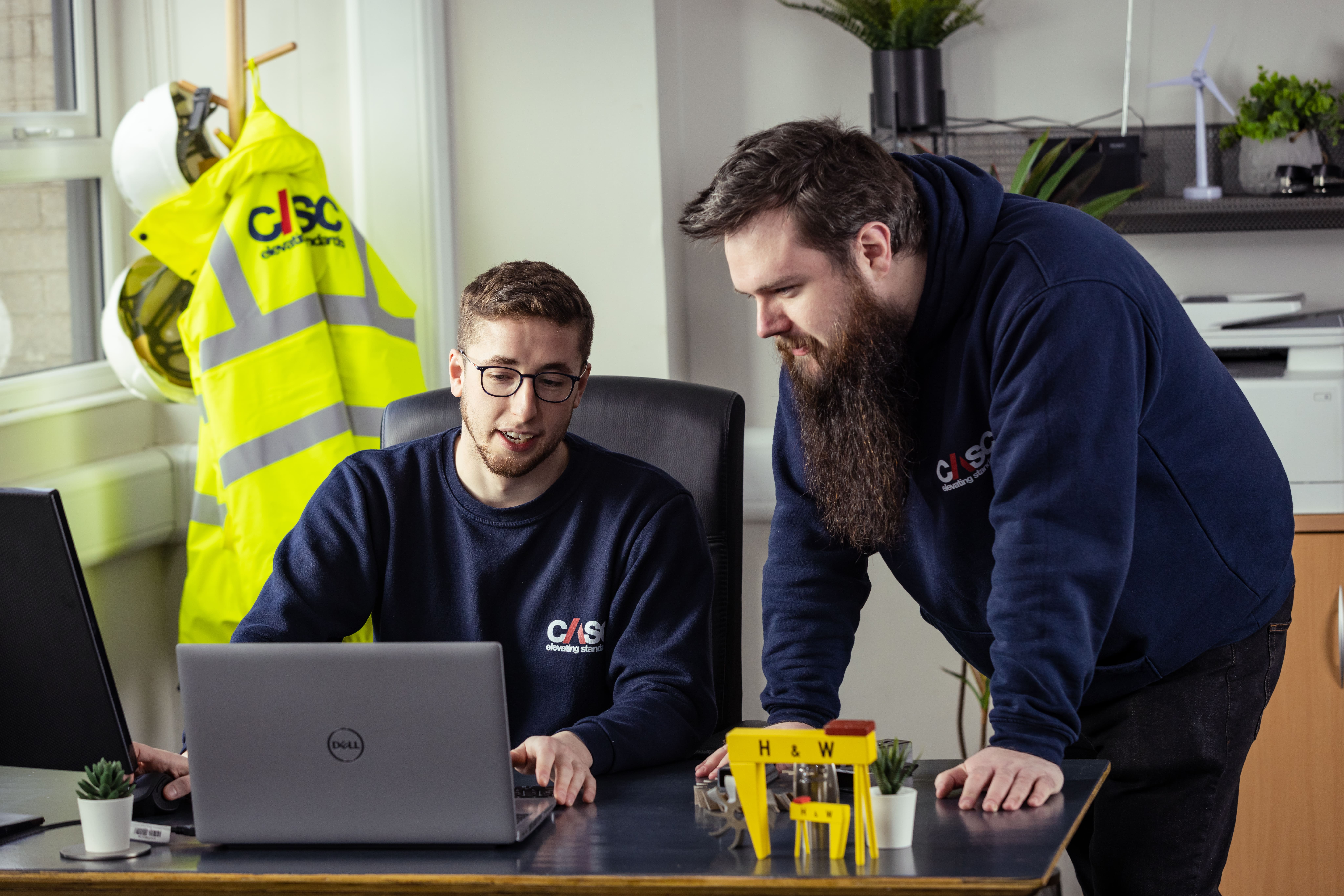 CASC team members standing at a desk