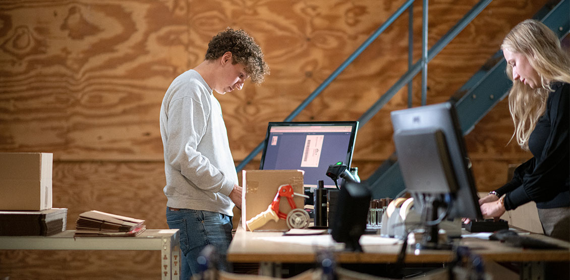 Retailers packing goods at a workbench