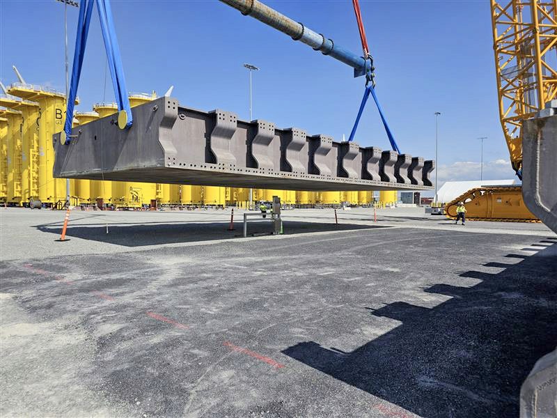Aerial view of an offshore wind turbine during installation at sea.