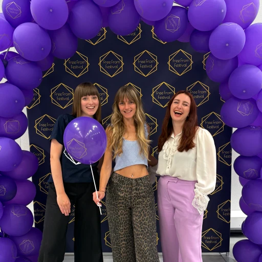 Margarita, Morgan and Ellie Standing in front of free from festival balloon arch