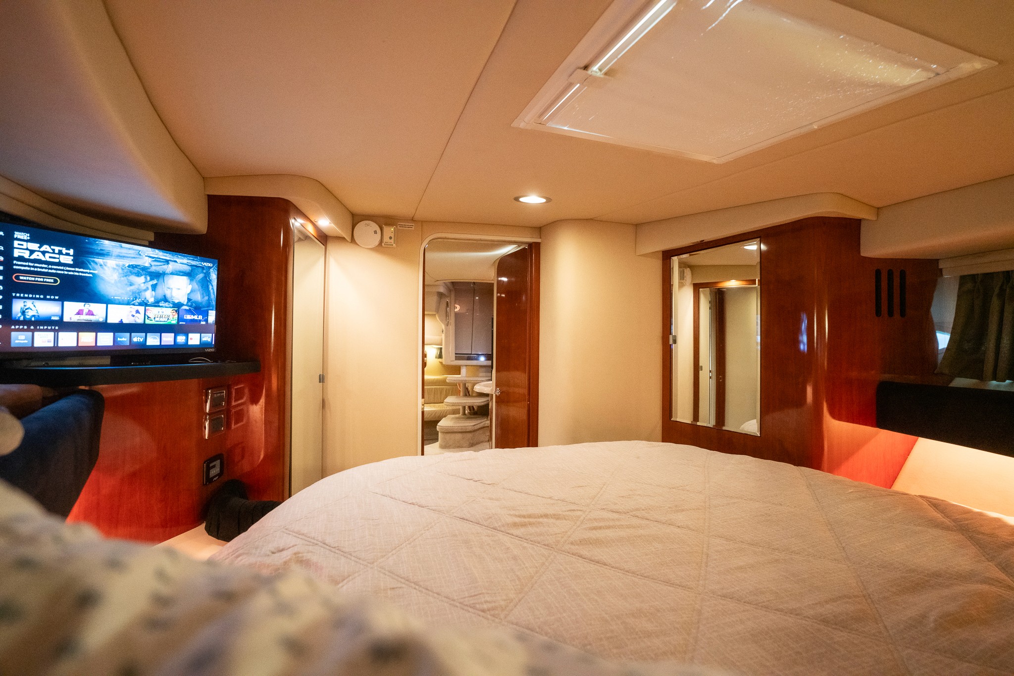 Yacht cabin sleeping quarters with warm finishes