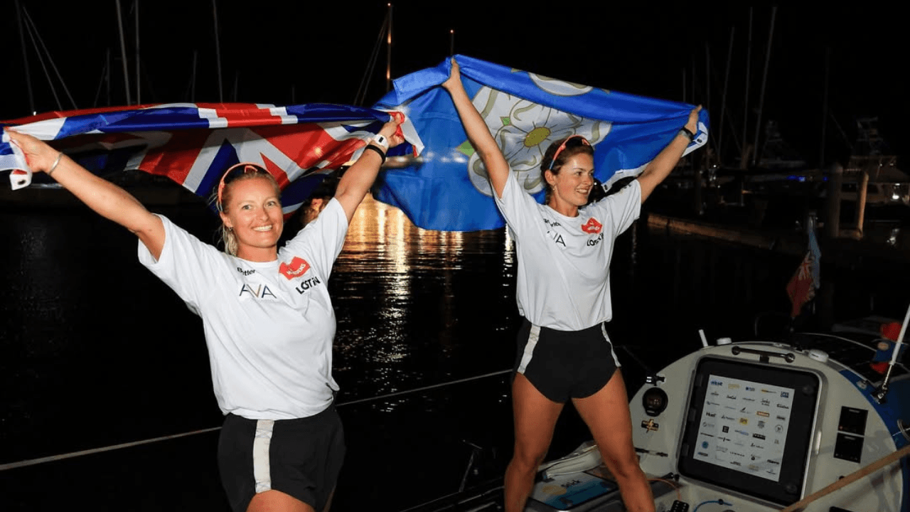 Miriam and Jess celebrating their arrival after completing a row across the Pacific Ocean