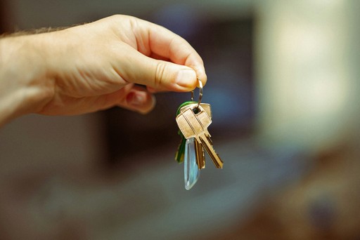A person holding a bunch of keys in their hand, illustrating housing services