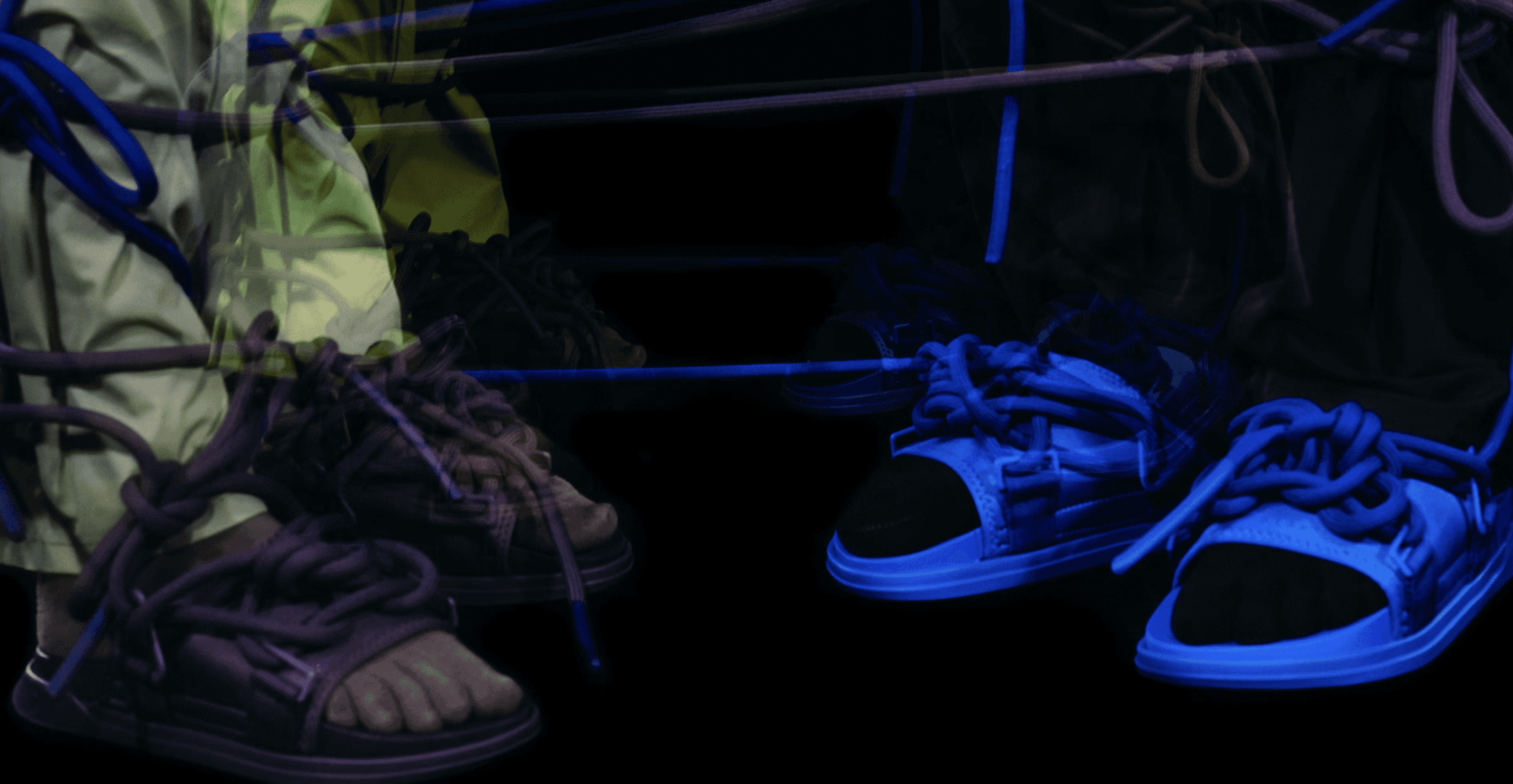 Woman in sweatsuit sitting on plant against wood wall