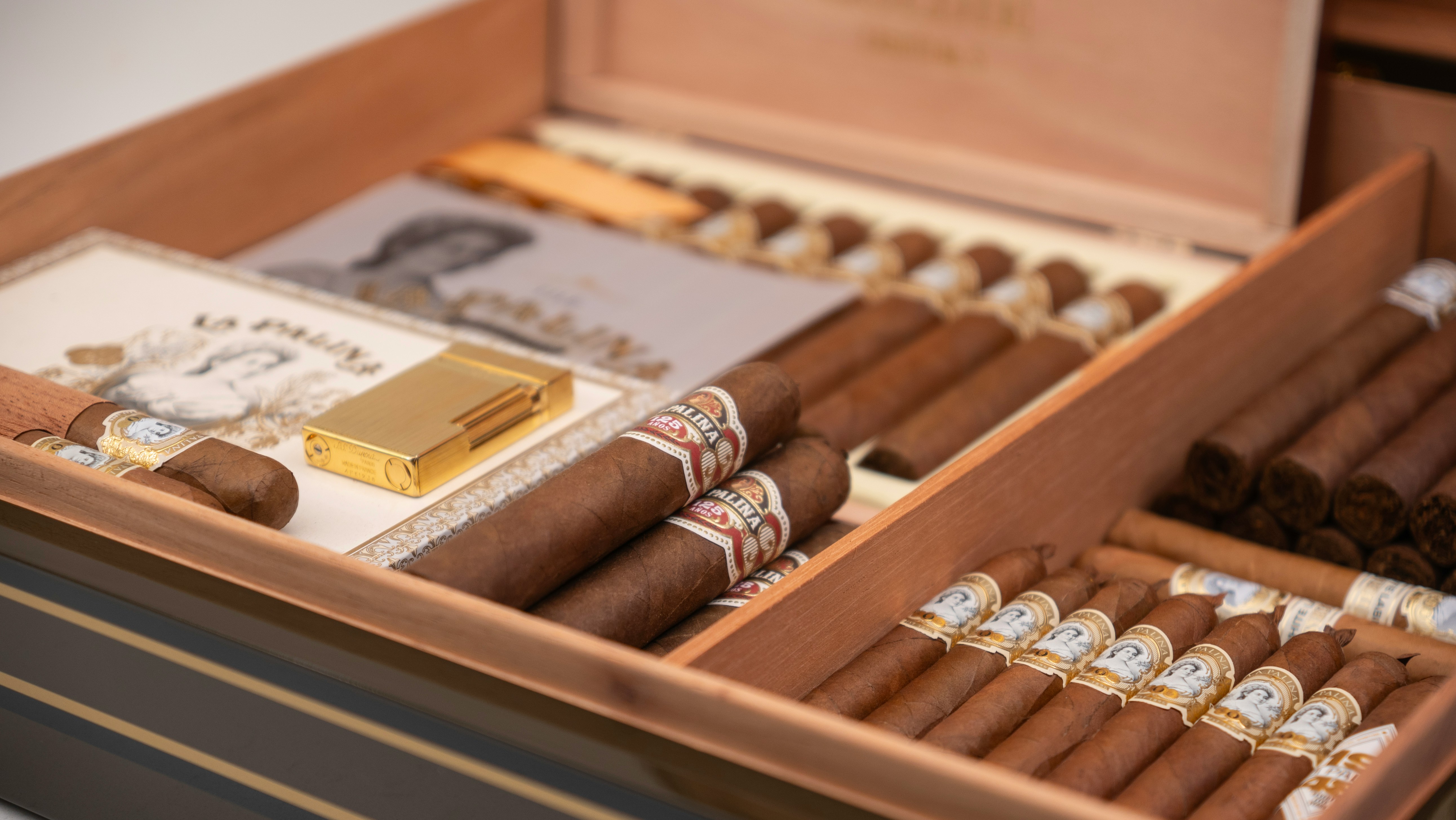 Cigars and accessories arranged in an open humidor.