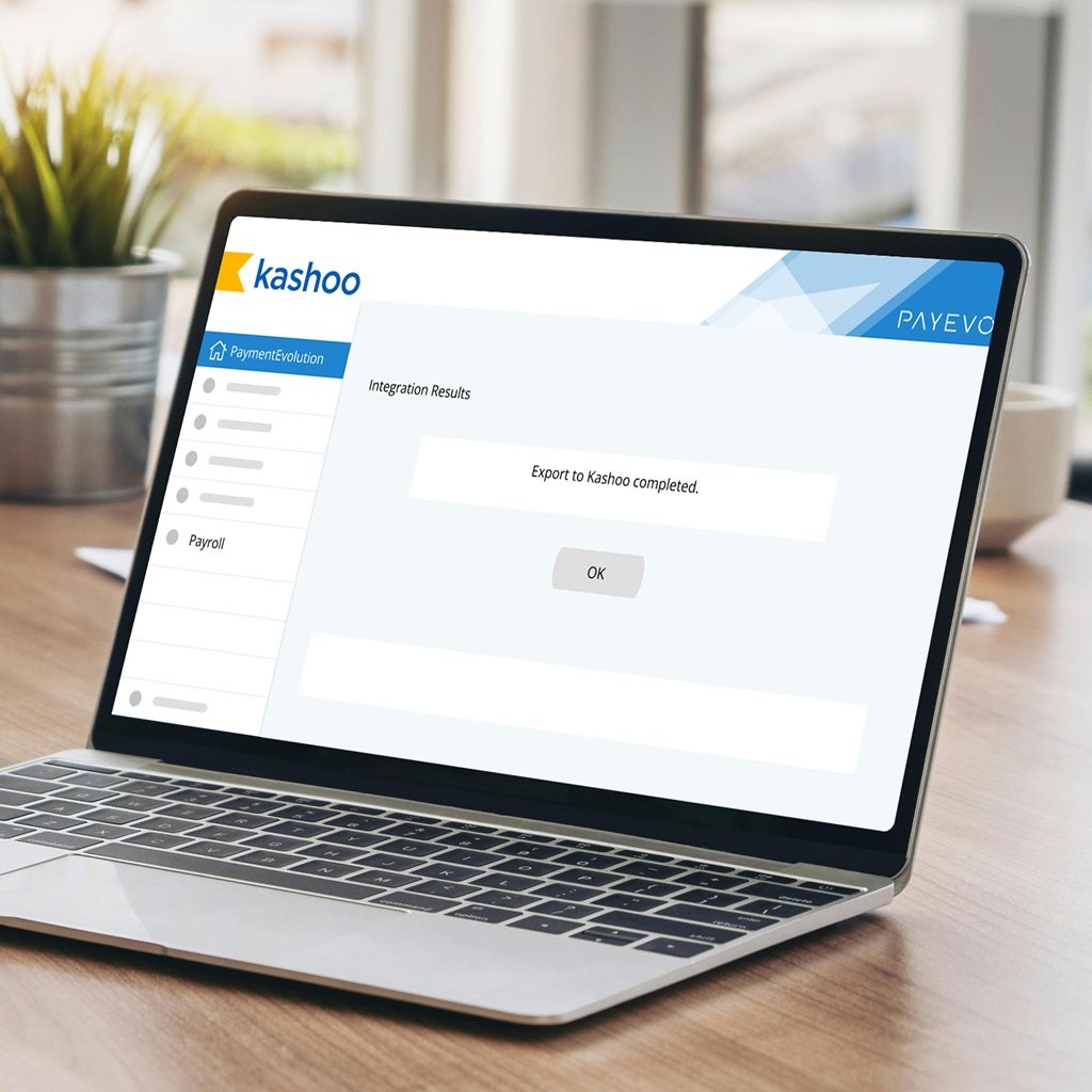 Laptop screen showing Kashoo integration results with confirmation message: Export to Kashoo completed