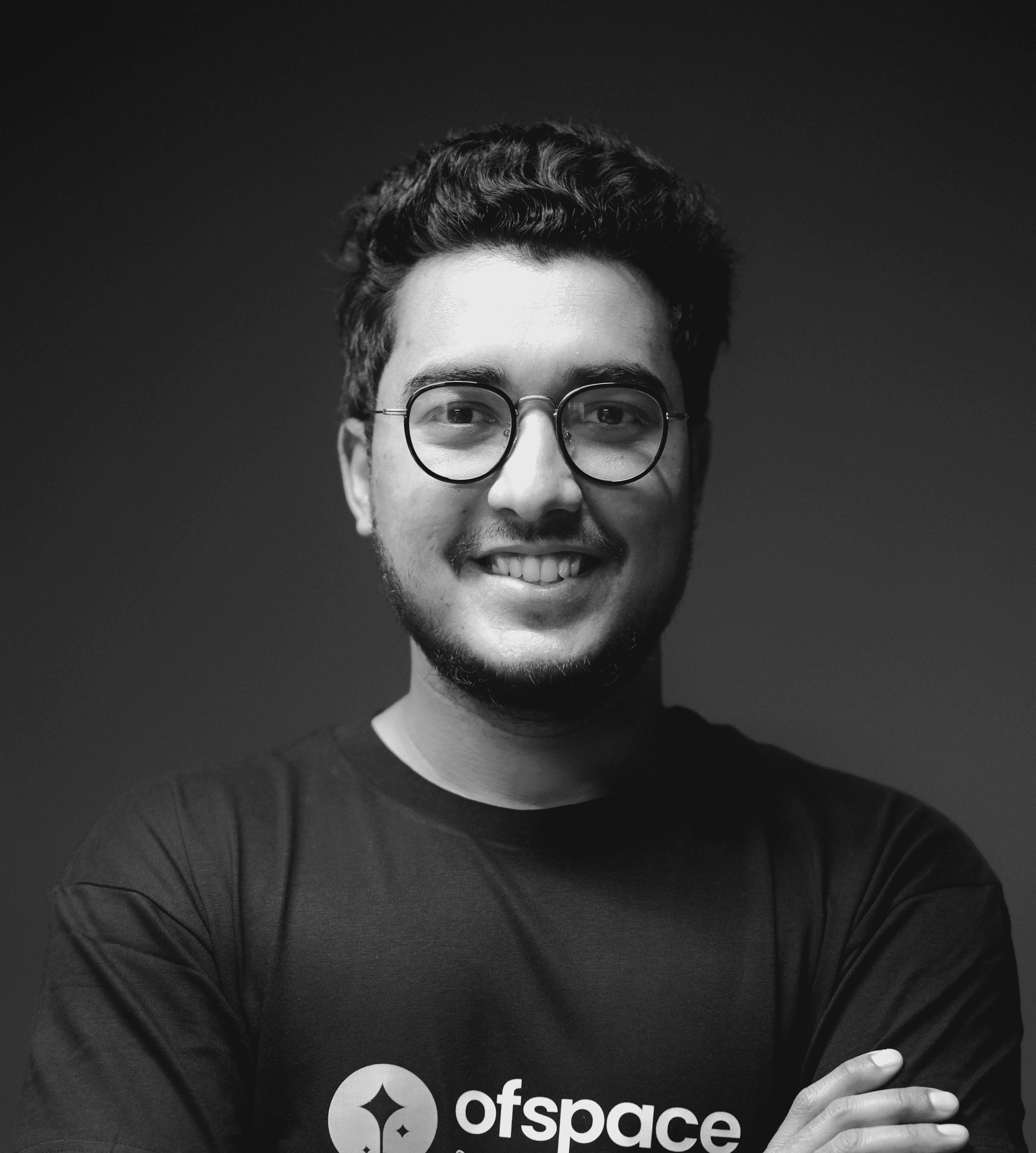 a man with glasses is posing for a picture