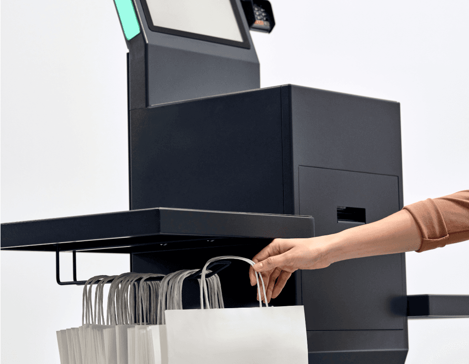 Picture of a person taking a bag off a shopreme matrix Self-Checkout Kiosk