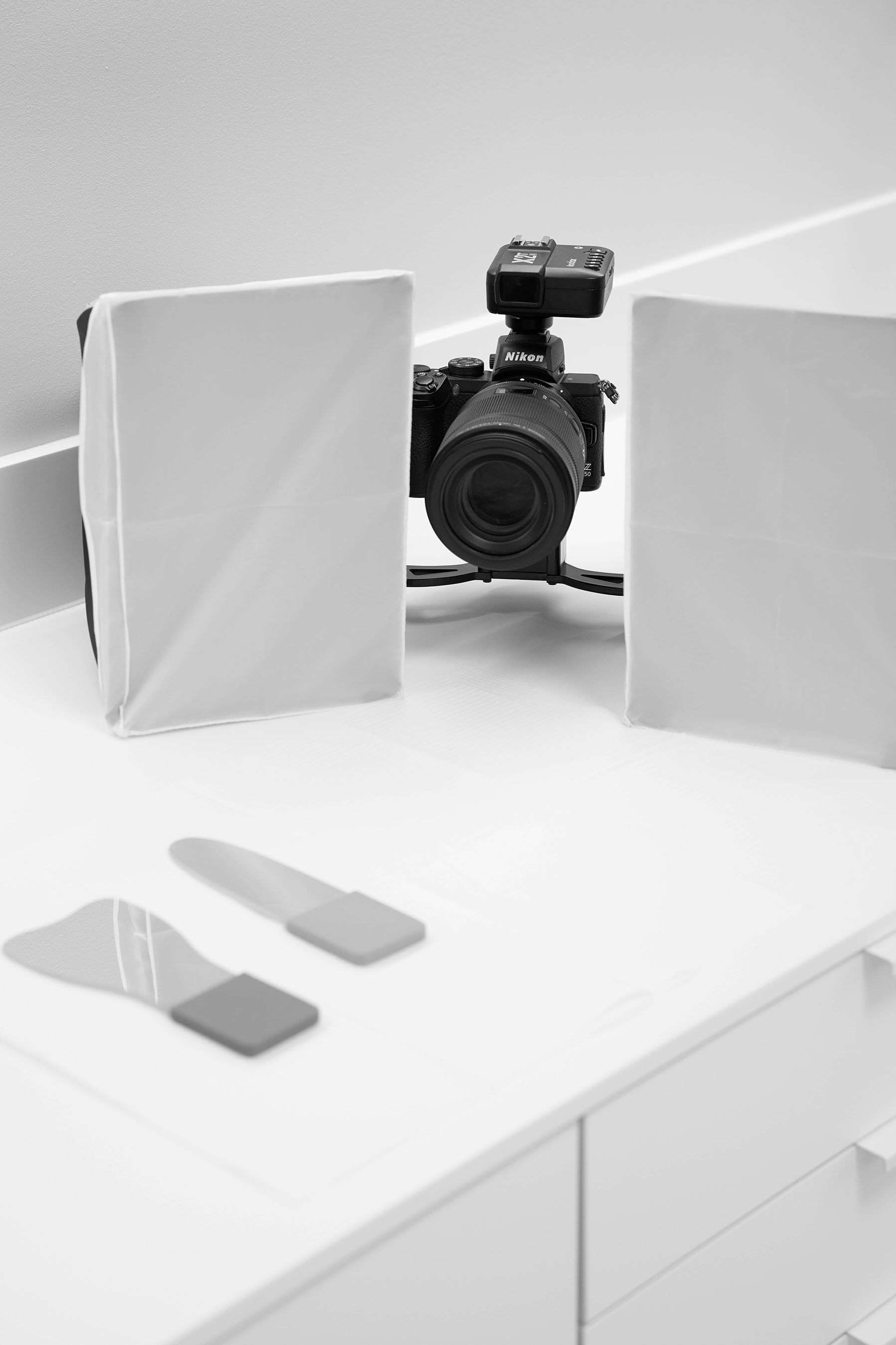 Kamera mit seitlichen Diffusoren für die Dentalfotografie auf einem weißen Arbeitstisch