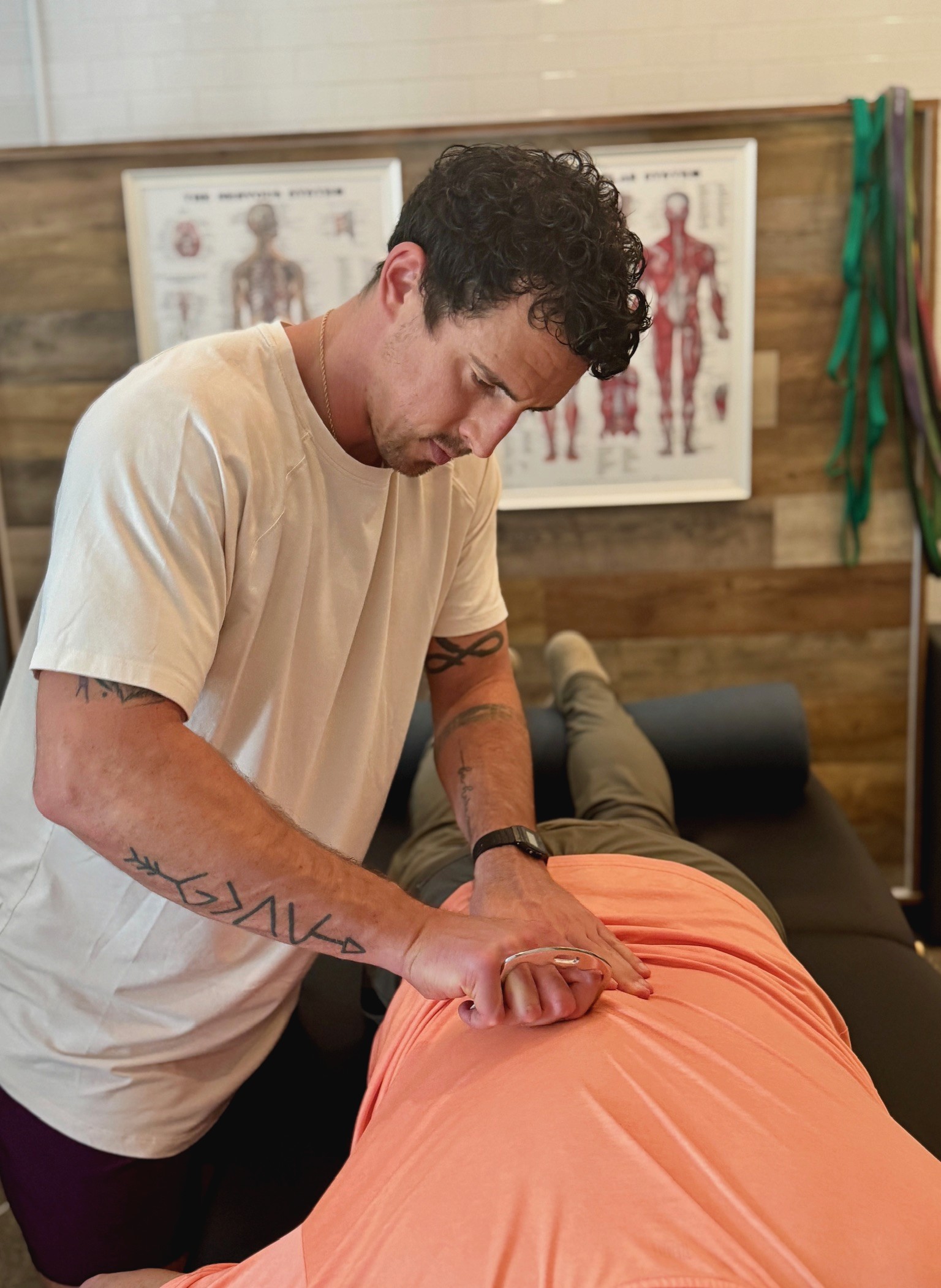 Physical therapist performing manual therapy on a client’s hip to improve joint mobility