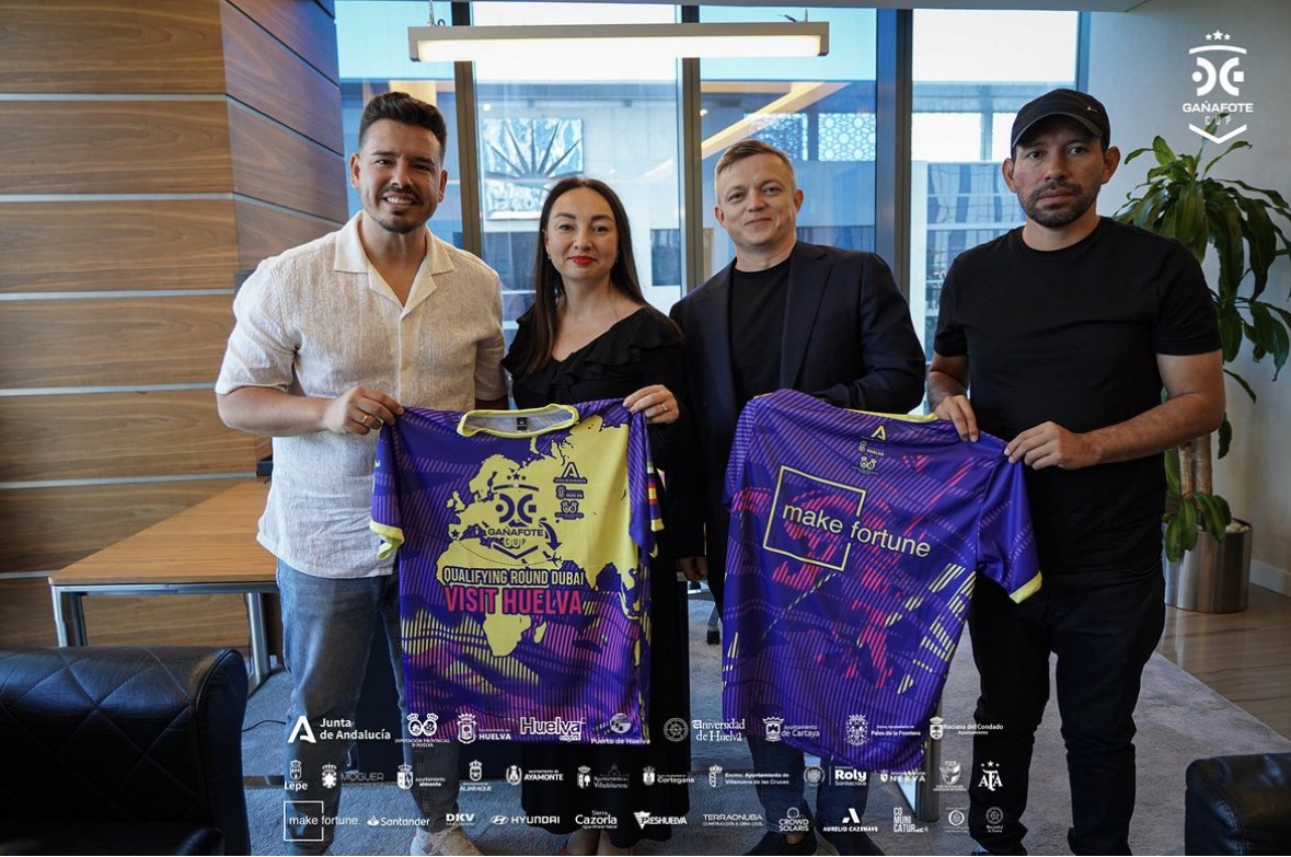Close-up of lush, dark green leaves, some glossy and wet, against a muted background.