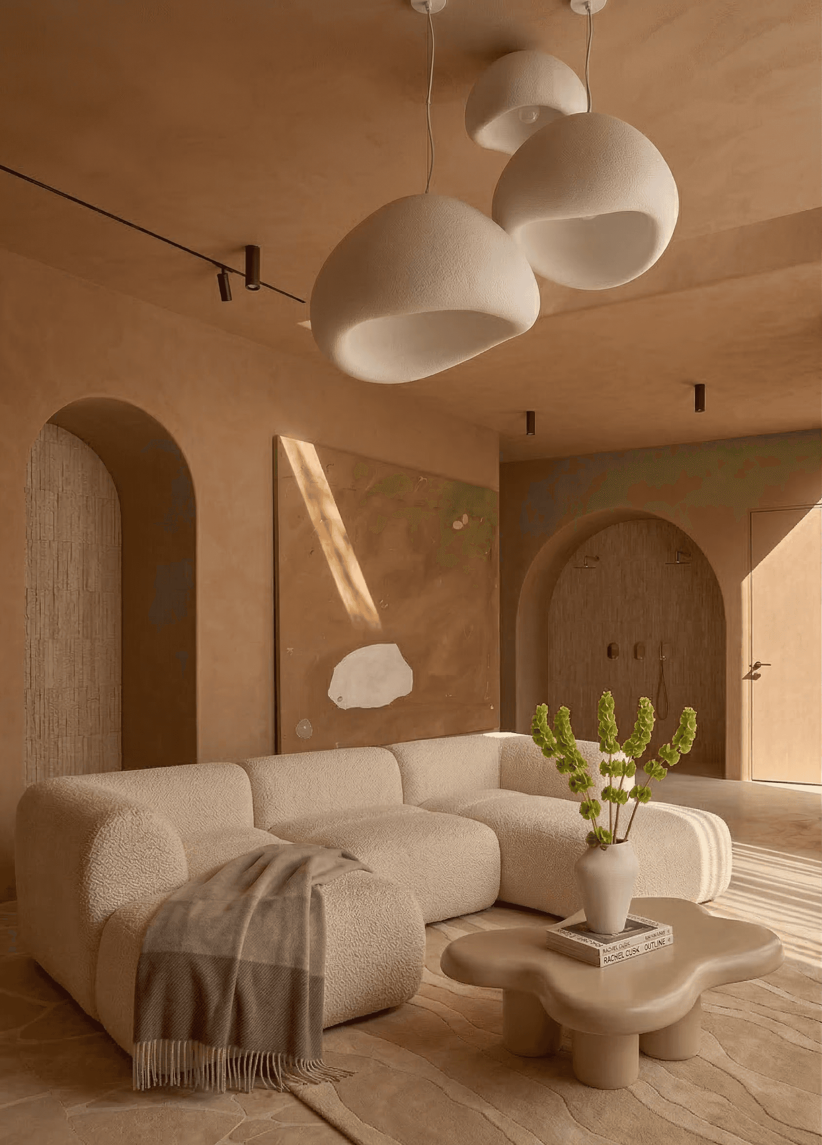 Modern terracotta architecture studio with curved ceilings, grid windows, round tables, stools, plants, and a contemporary chandelier.