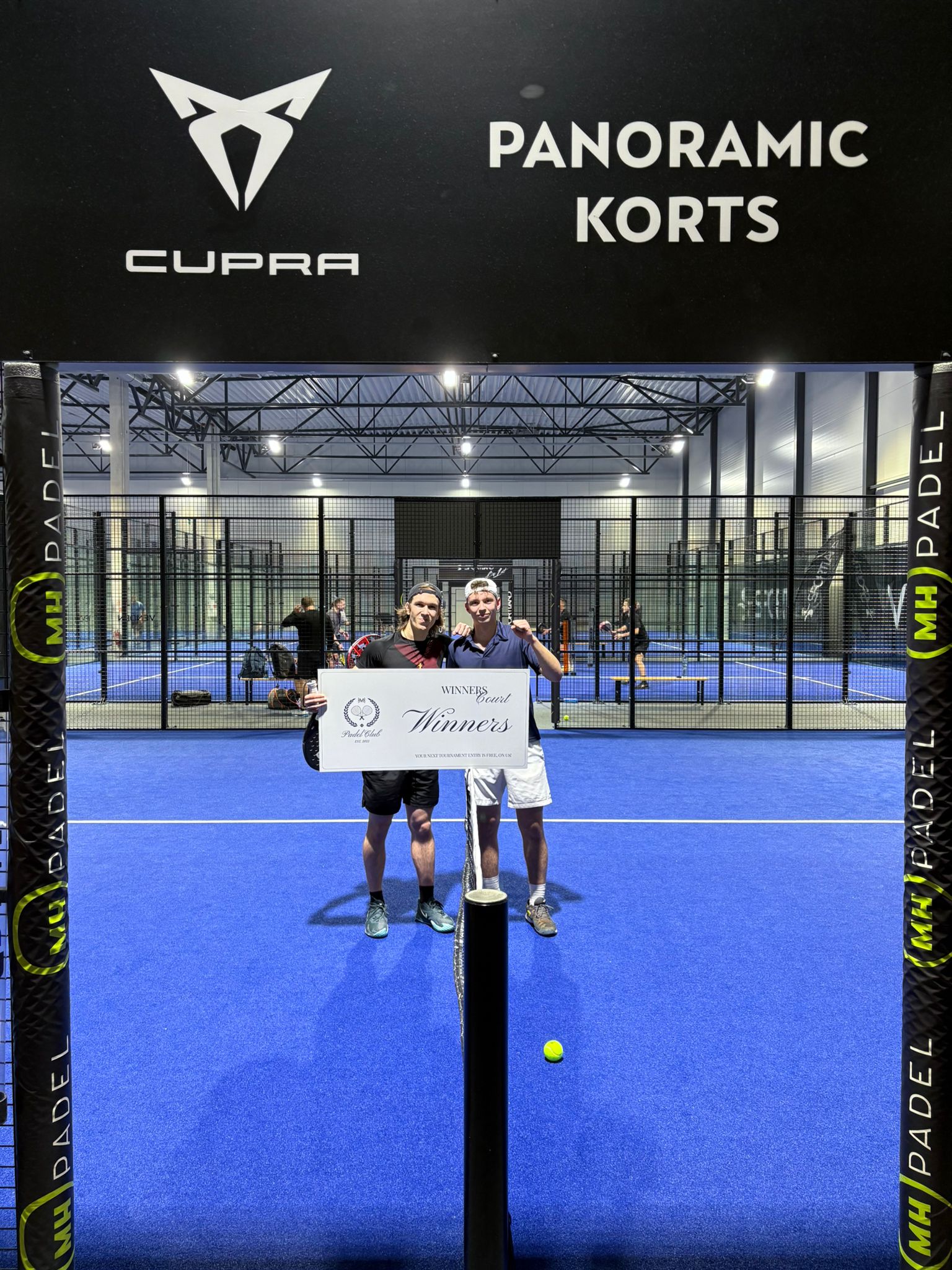 A group of men standing around each other in a room