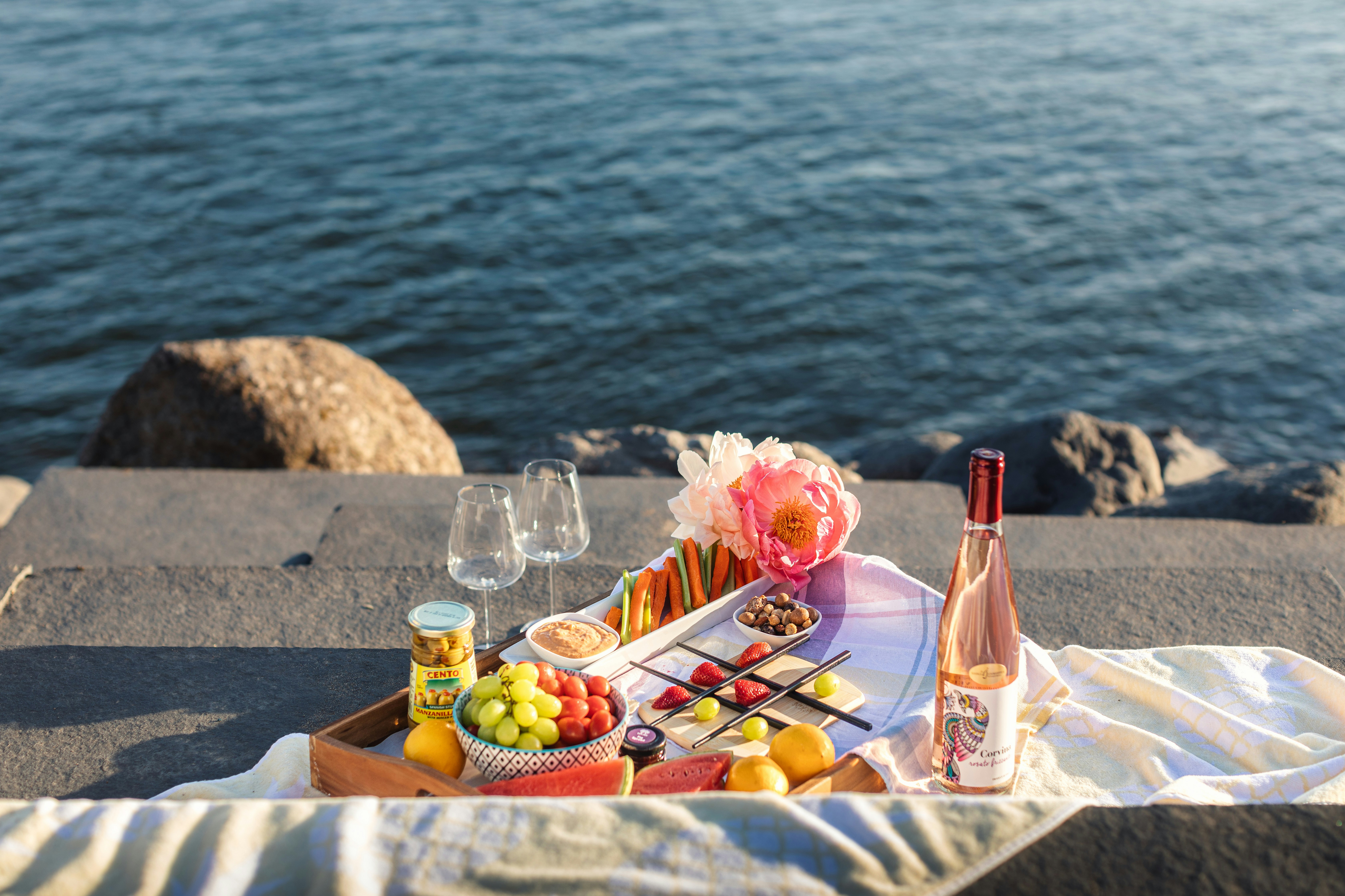 a tray of food sitting on top of a table next to a body of water