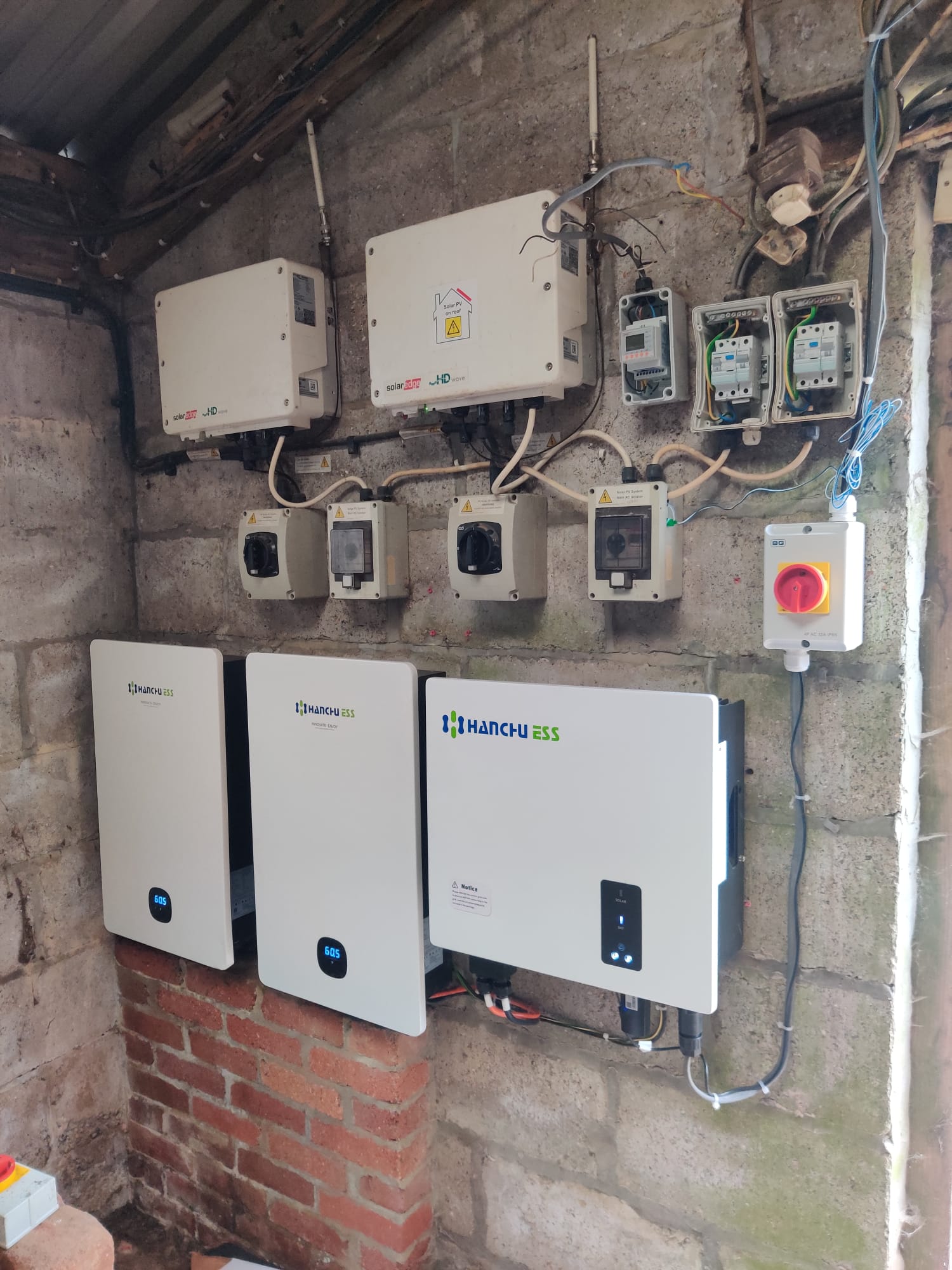 Solar inverter and isolator installation on a wall by Solar Panels London