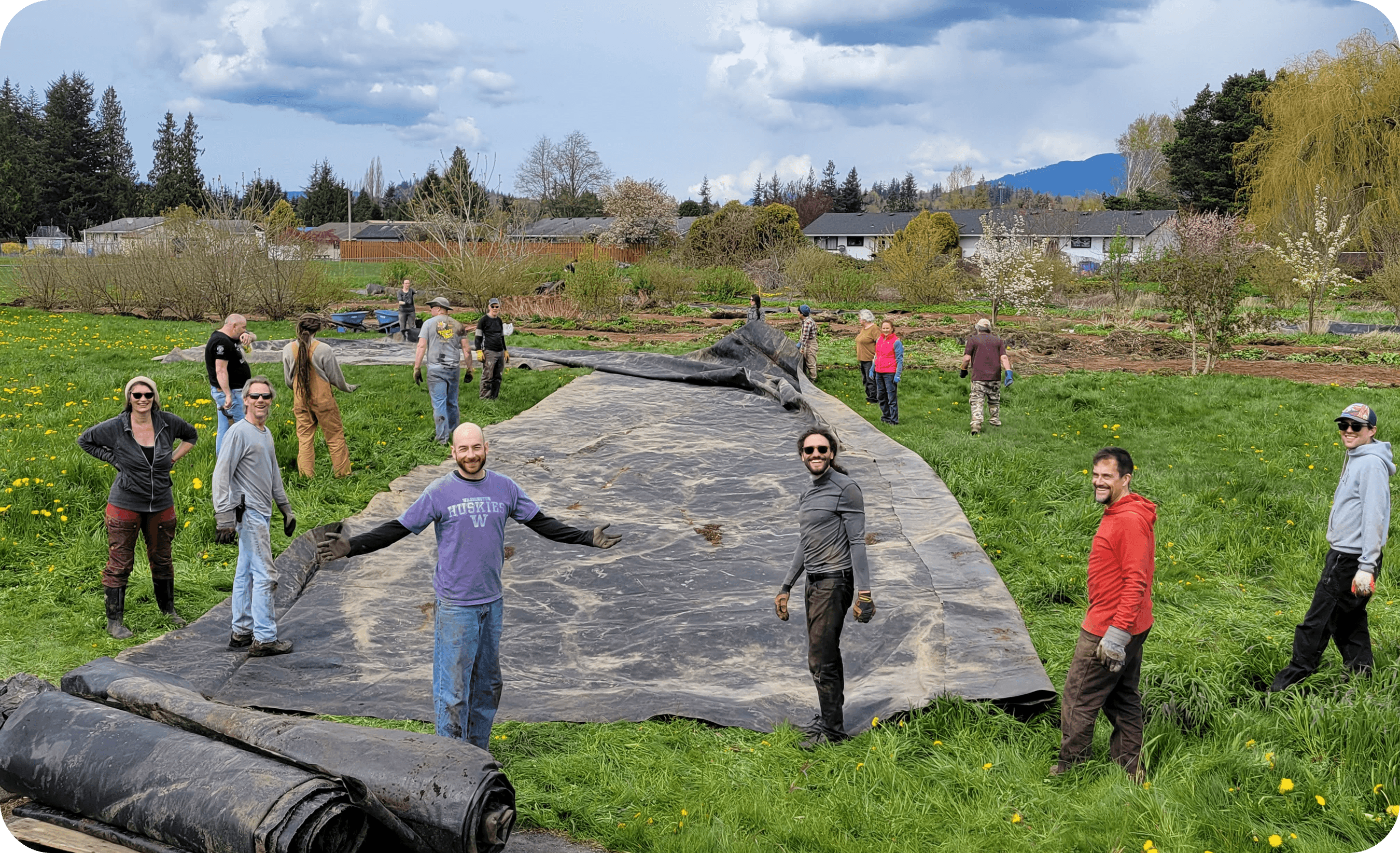 Community members gathered together indoors in conversation during a cohousing meeting.