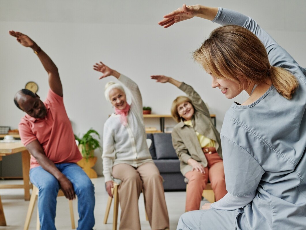 group of seniors taking a class for chair workouts for older adults