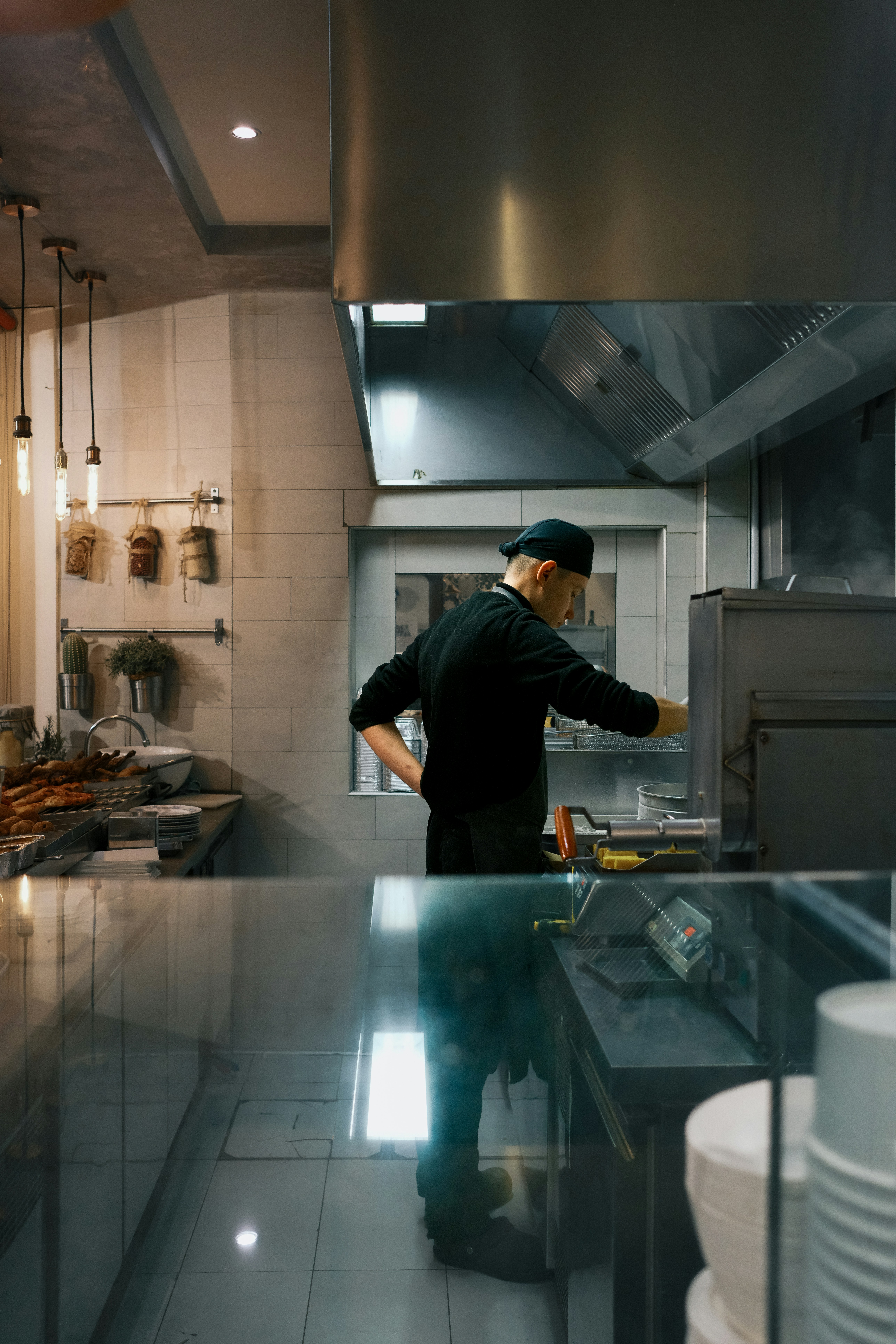 A chef works in a restaurant kitchen.