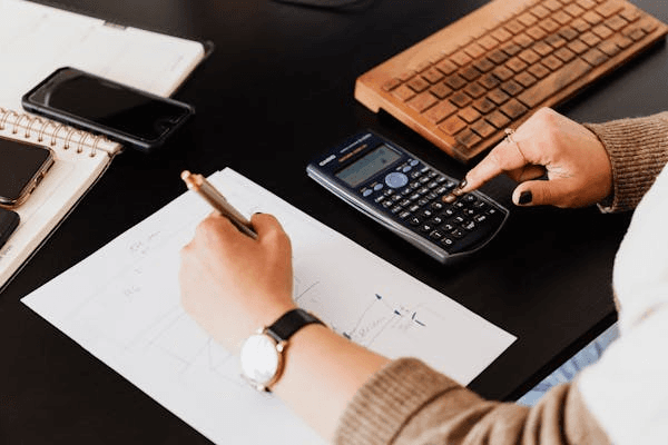 Person using a calculator for bookkeeping.