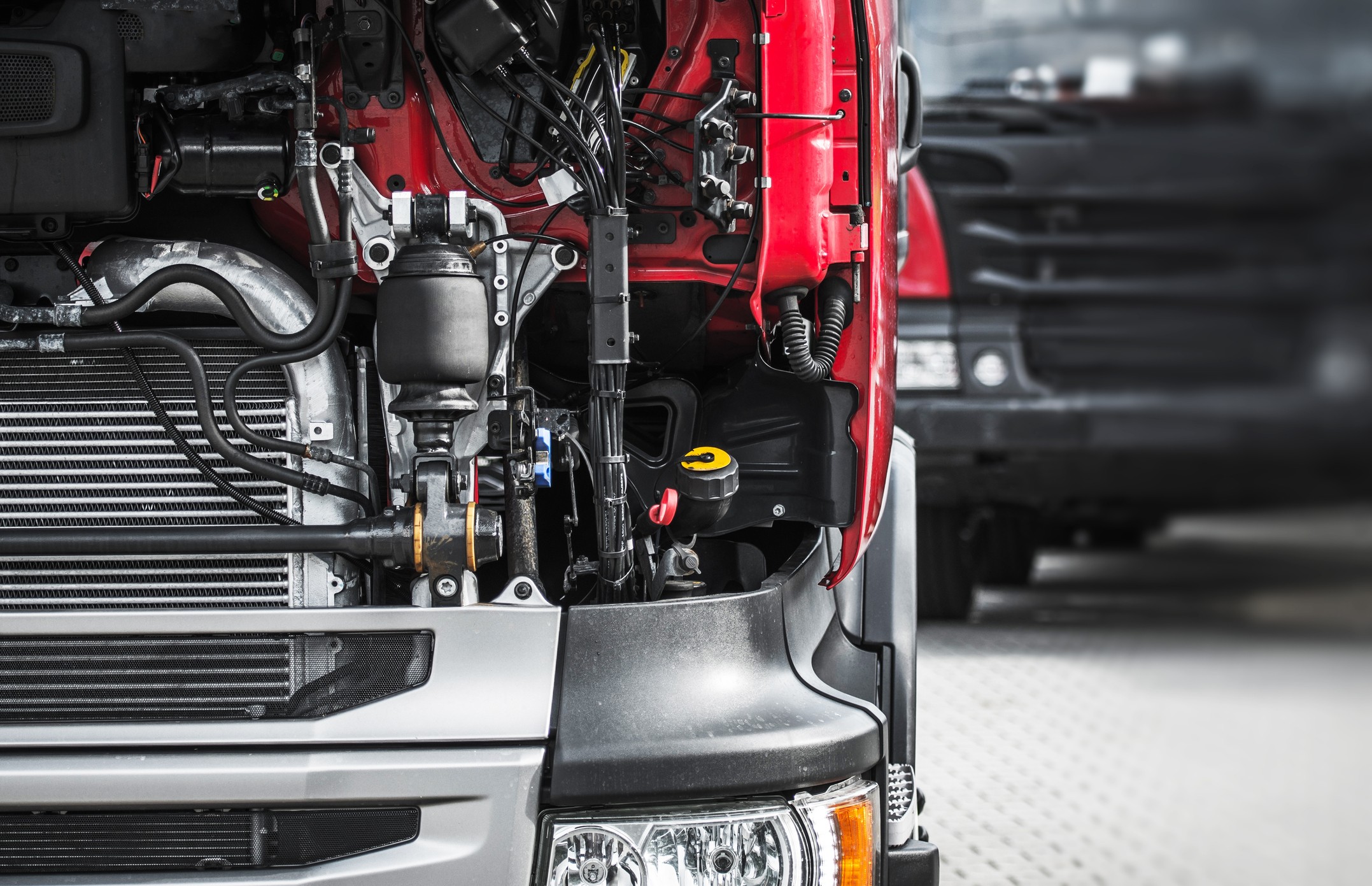 Man in Black Uniform and Blue Cap Fixing Blue Truck