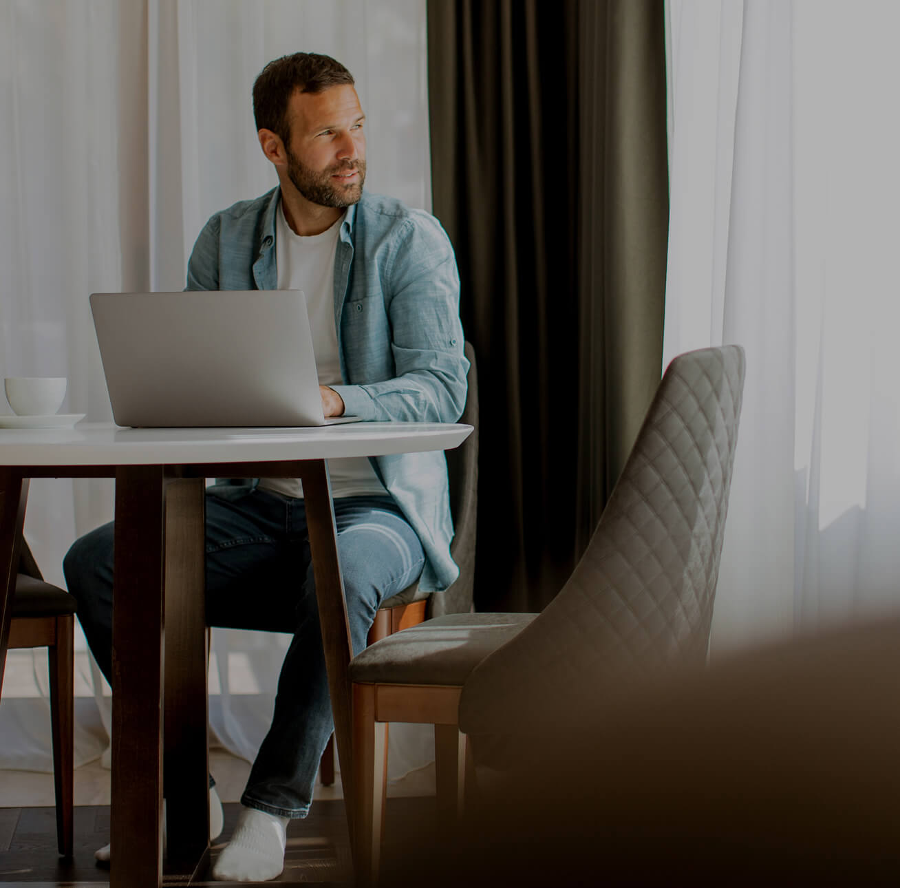 A man sitting at a desk on a laptop