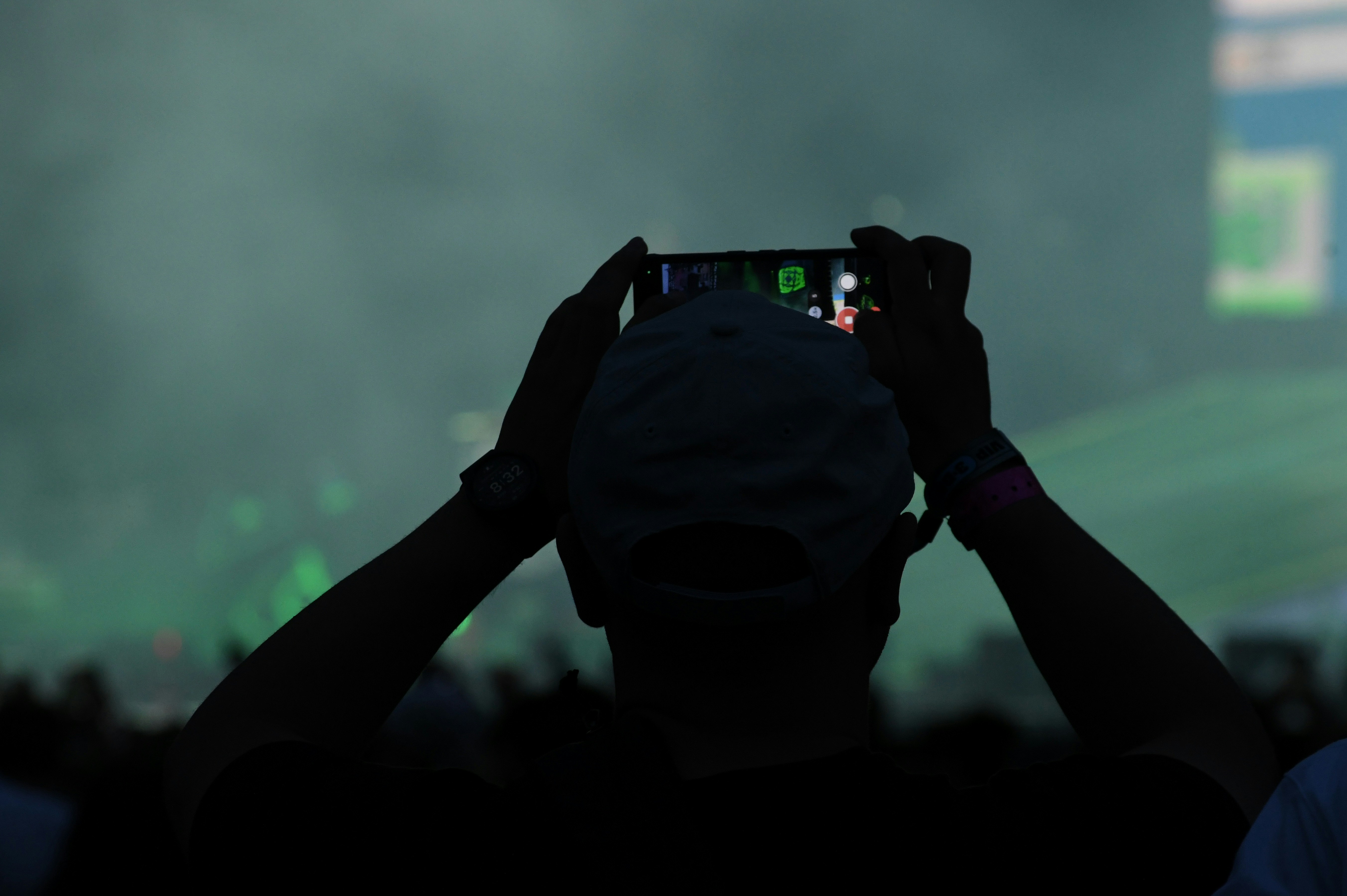 Person records event with their phone.