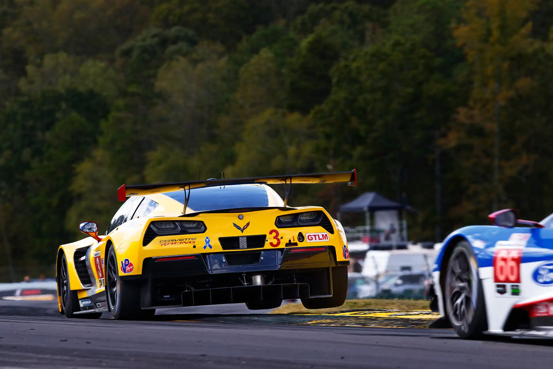 A yellow racecar on track.