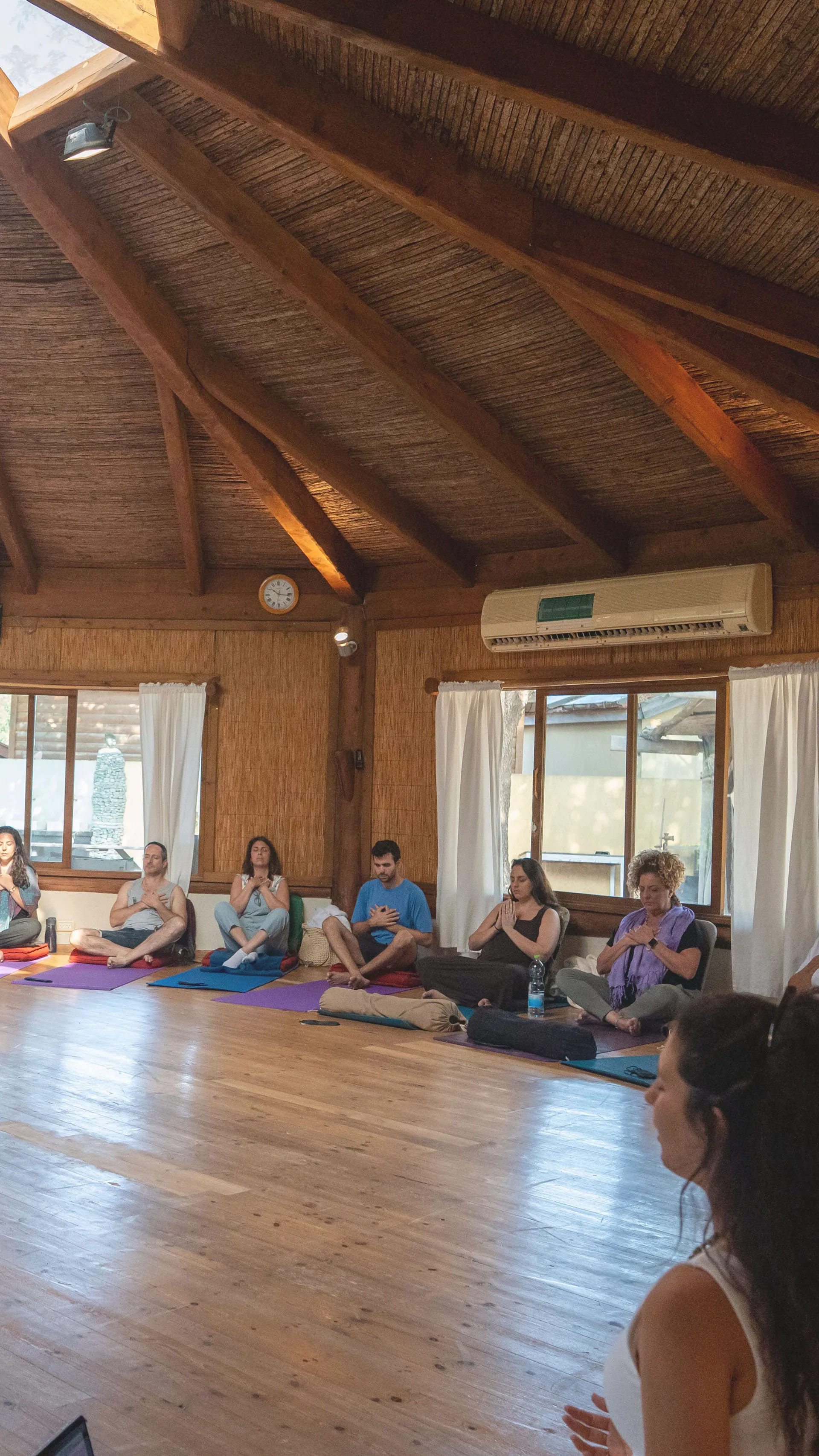 A half circle of people seating in a meditation position, and Gal is the Guider