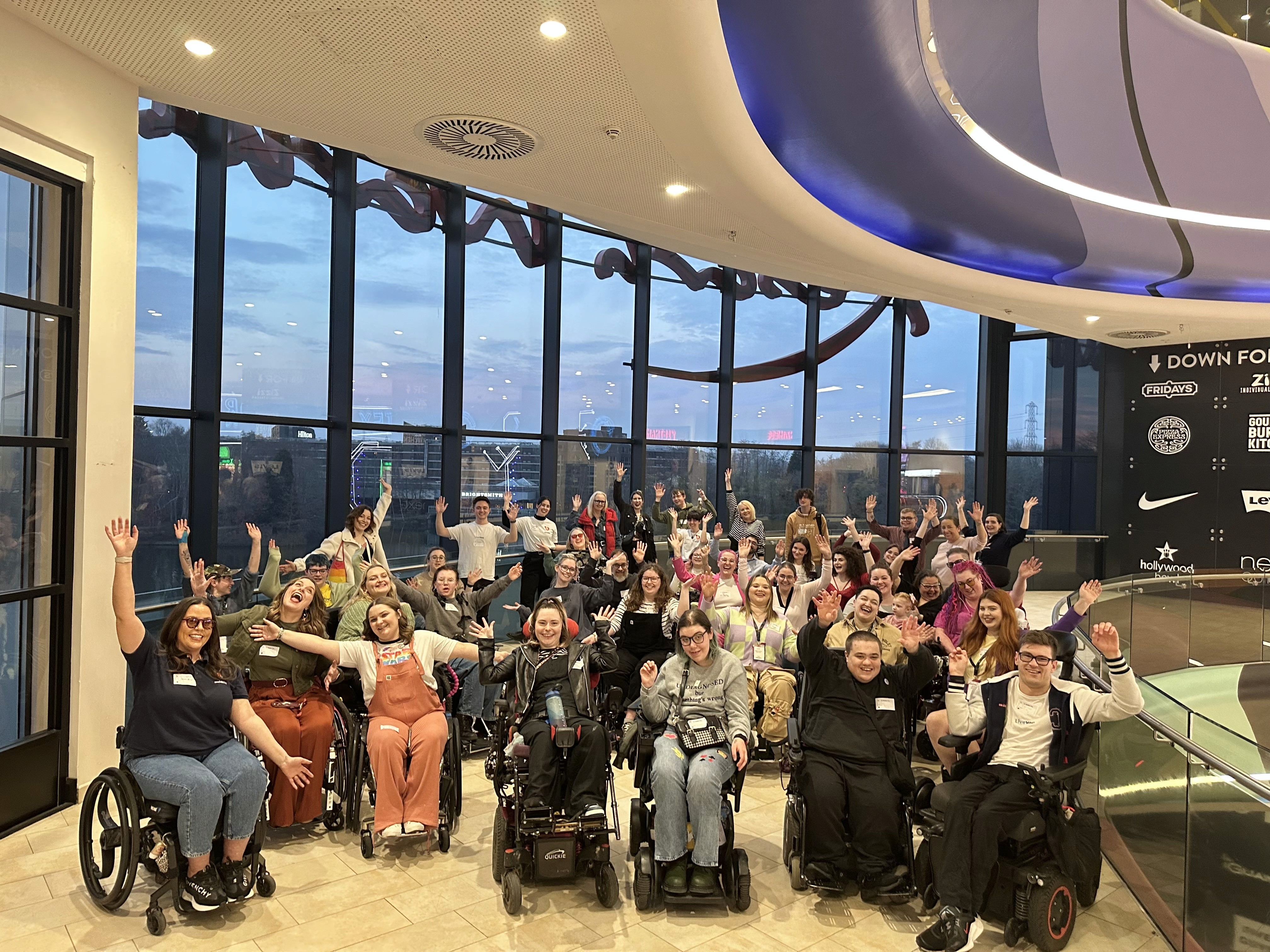 Sociability users with different disabilities celebrating at Naidex community event.