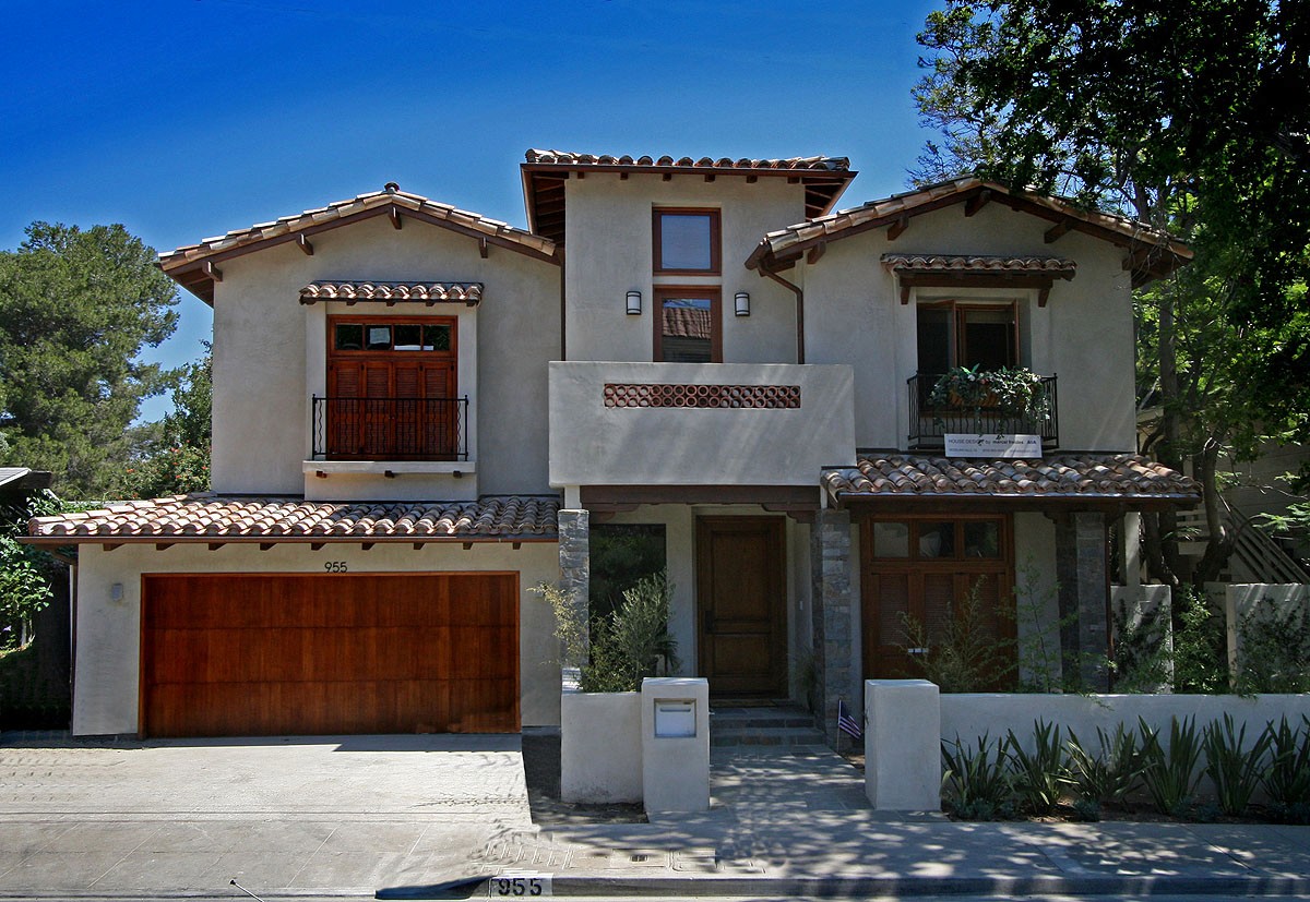 Exterior view featuring a Spanish roof and wood accents, highlighting the traditional yet modern design elements.