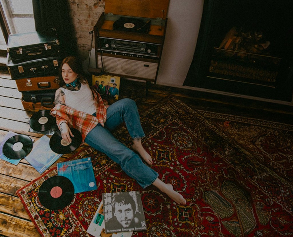 Vintage-style photo of a person with vinyl records and text: "Neo-Nostalgia: Why Retro Design Is Shaping Modern Branding.