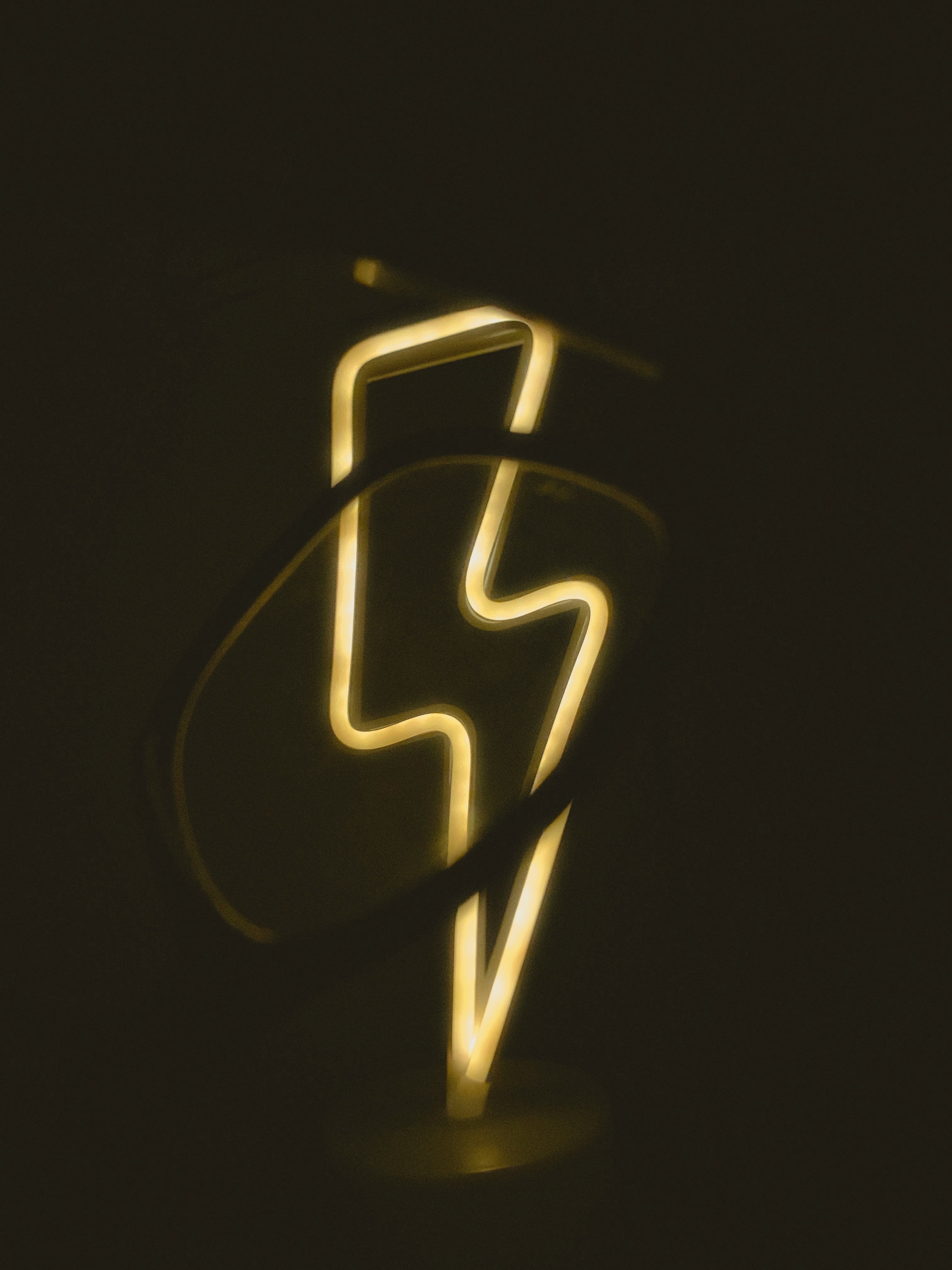 a close up of a neon sign in the dark