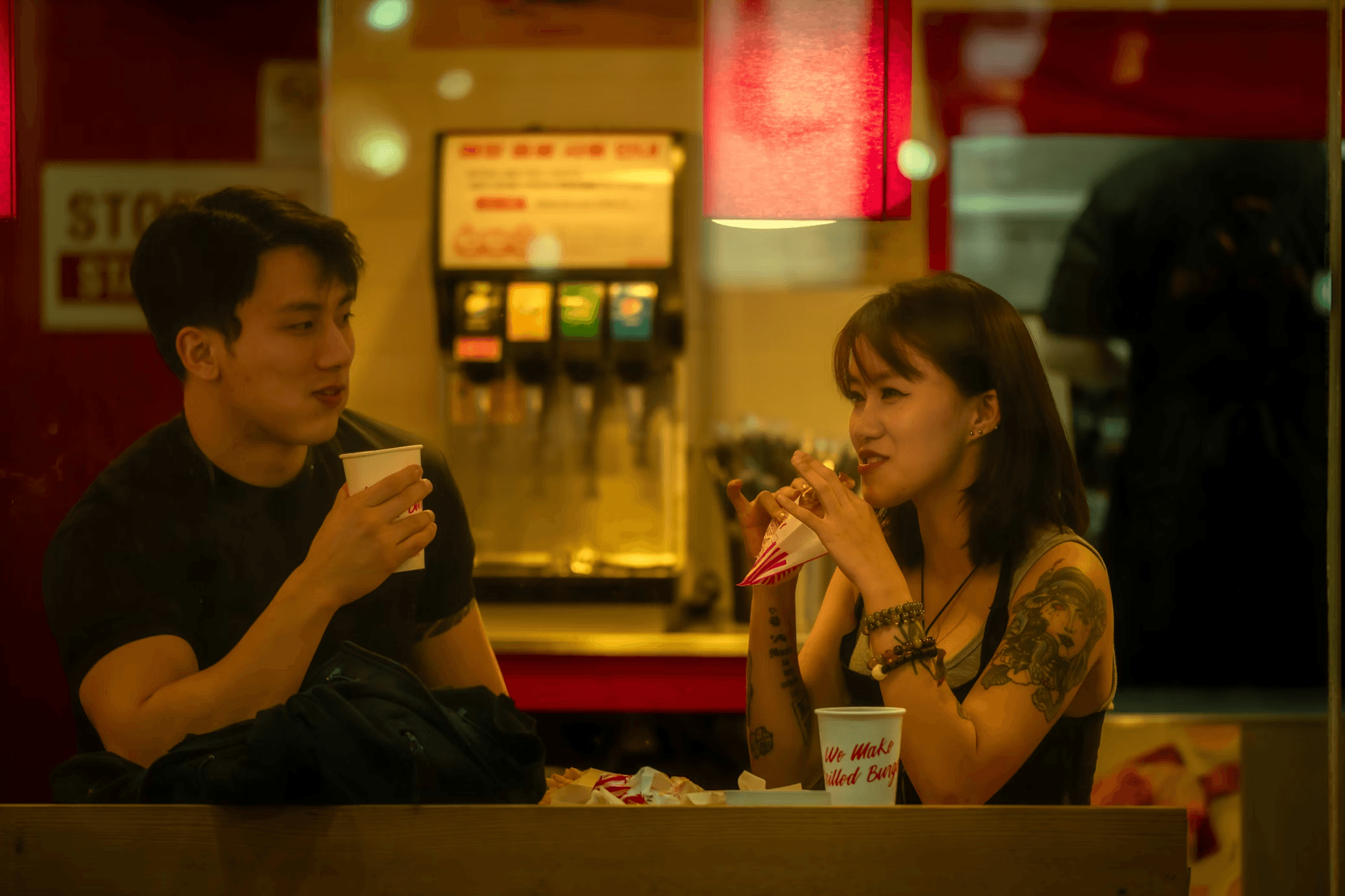 two people enjoying their dinner at a burger joint