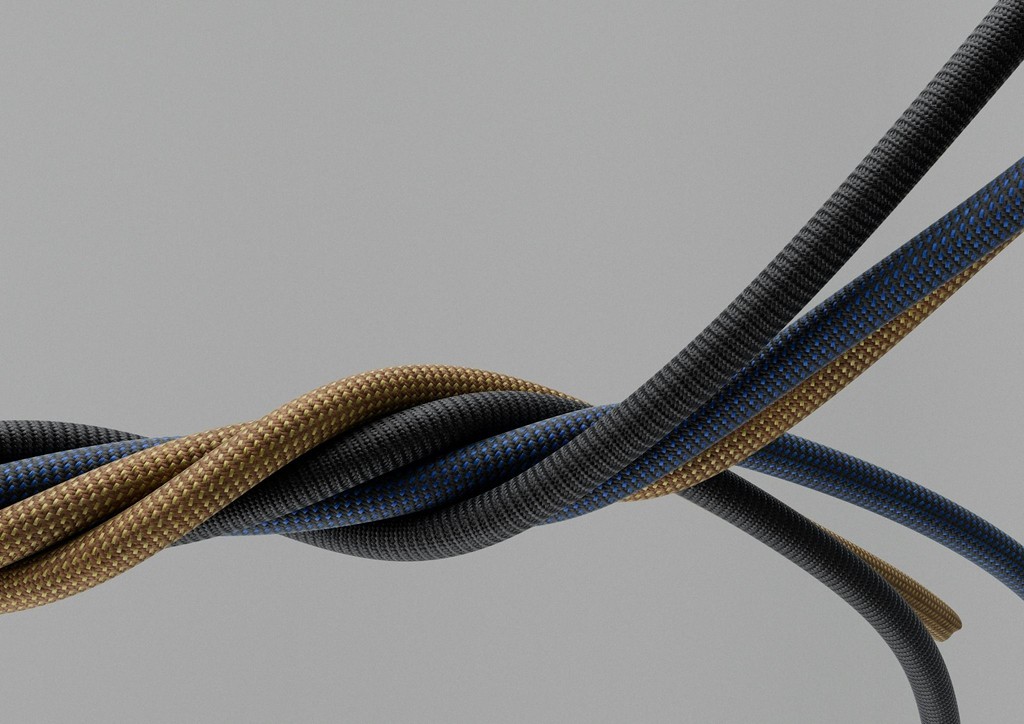 A close-up of three twisted wires in black and brown, set against a light gray background.