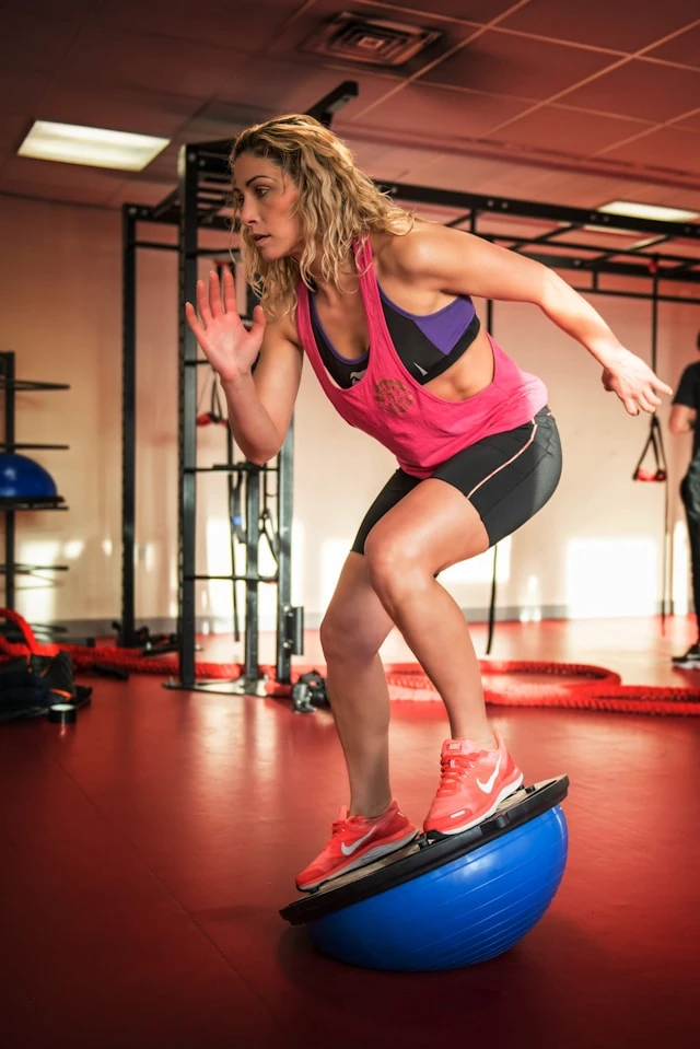 Woman doing a fast lateral training movement in a gym studio
