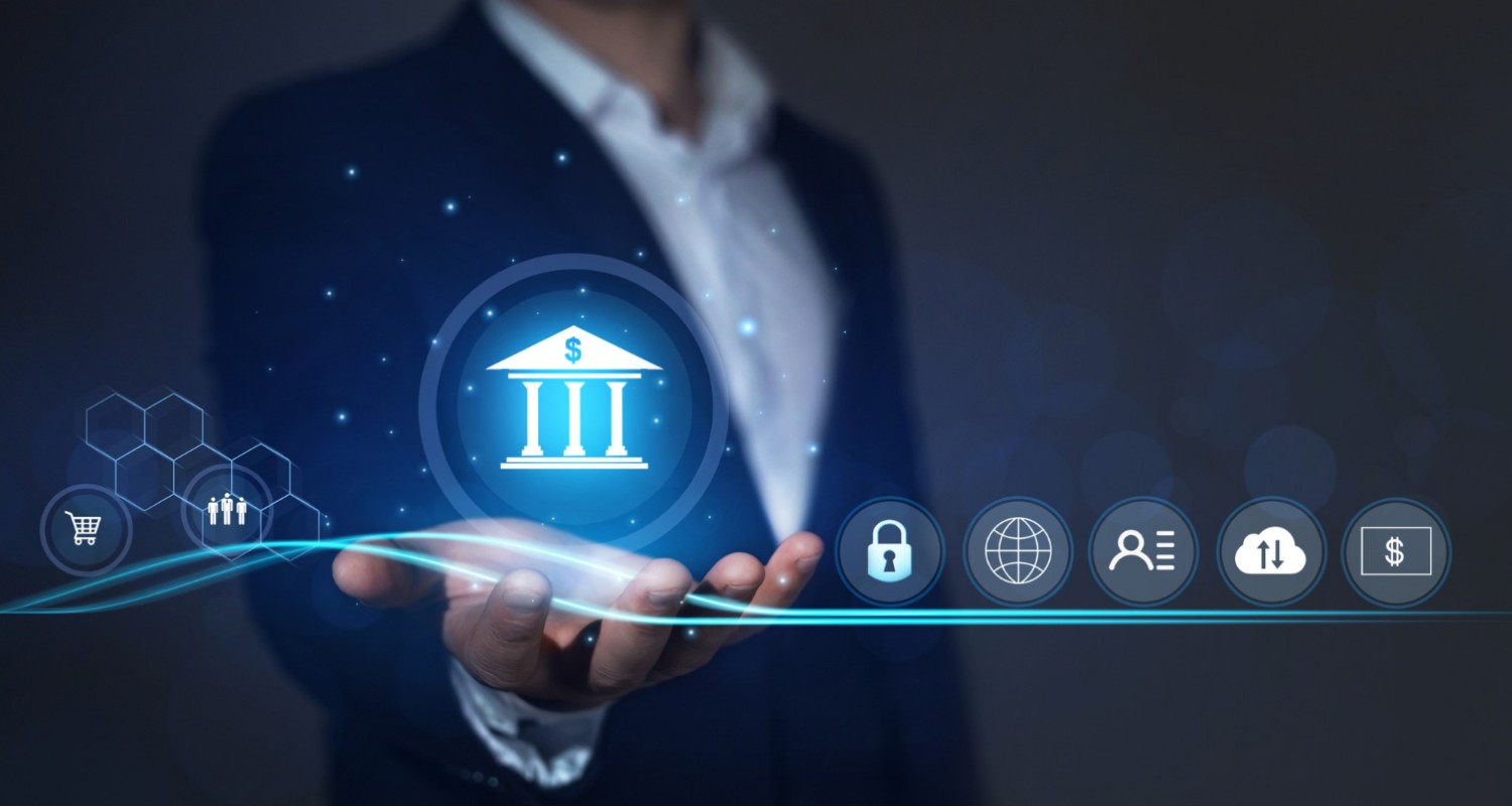 A business professional holding out their hand with a glowing digital banking icon hovering above it, surrounded by security, cloud, user, and currency symbols, representing financial protection and anti–money laundering prevention.