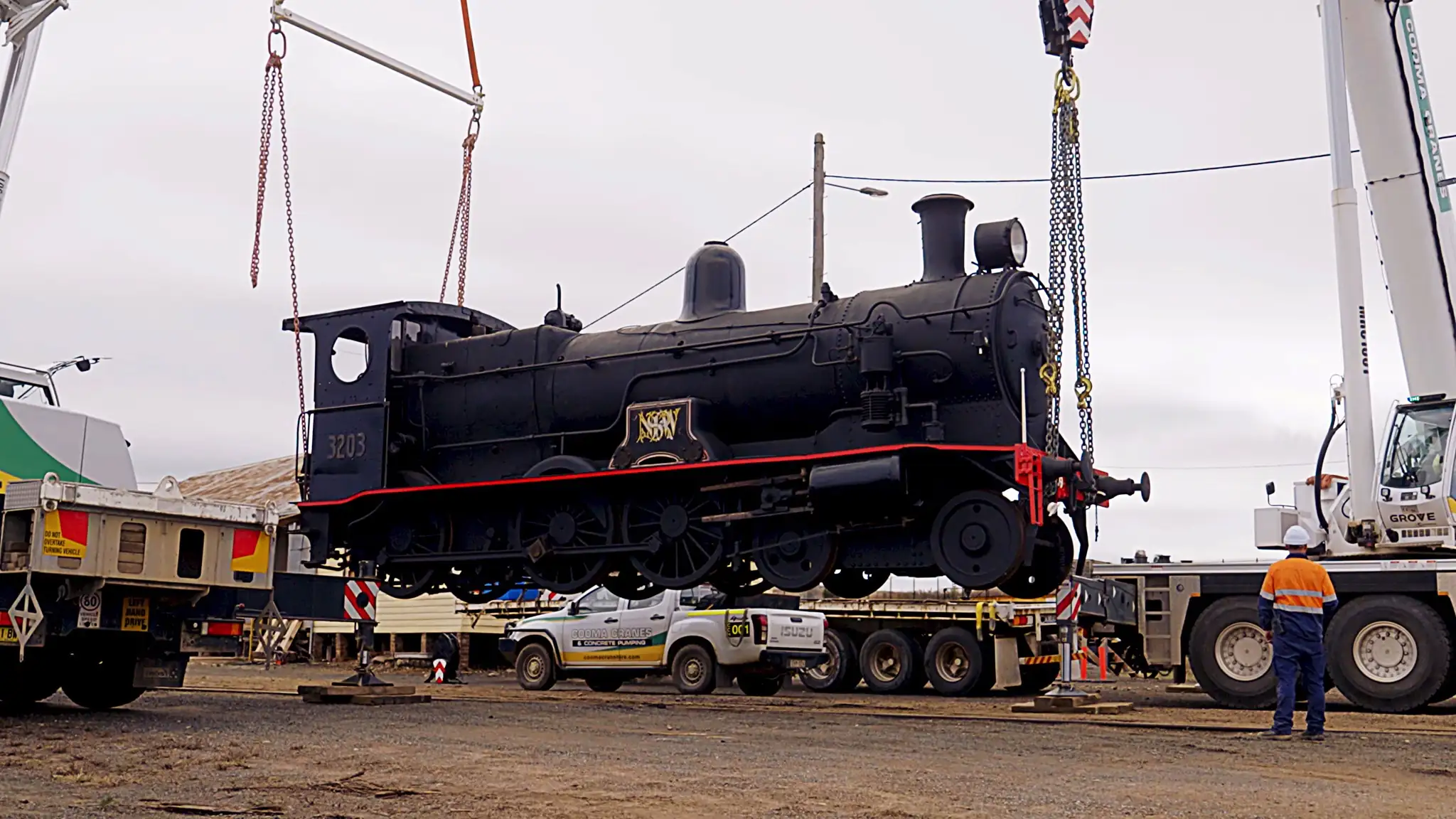 Locomotive 3203 is lifted by crane.