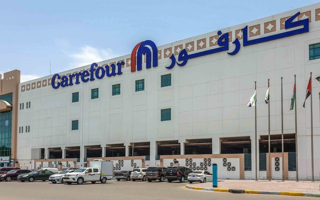 Carrefour store in Al Qurm, Abu Dhabi, showcasing a modern retail environment with various products and shoppers.