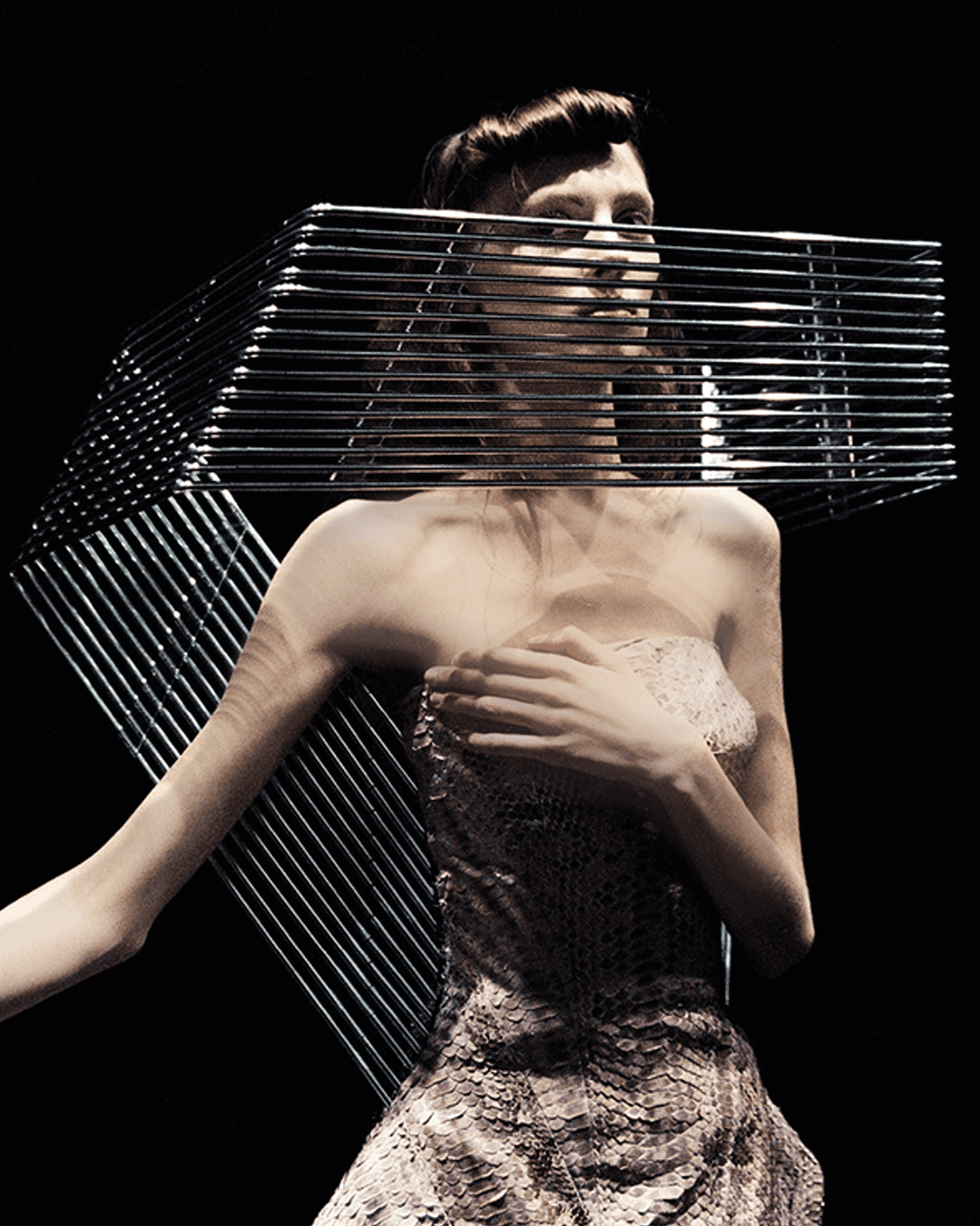 Fashion model wearing the bespoke Grille Collar by Shaun Leane, a hand-forged aluminium visionary neckpiece constructed from 15 parallel tubes.