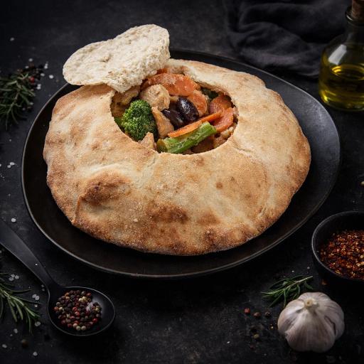 a white plate topped with meat covered in sauce