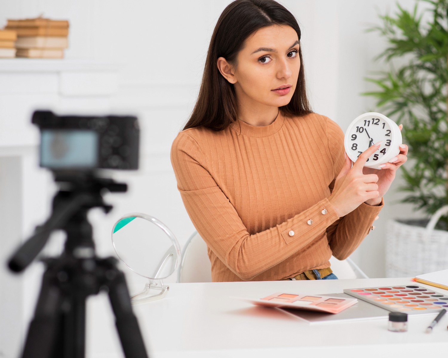 A woman stands before a camera, holding a clock, symbolizing the passage of time and the importance of moments.